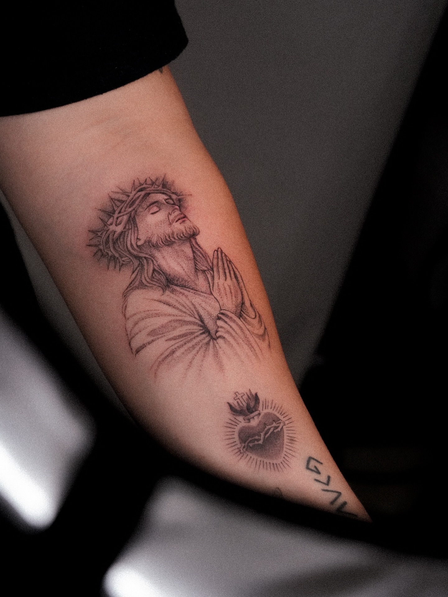 Jesus Christ praying realism tattoo on the forearm by Joy Christiana