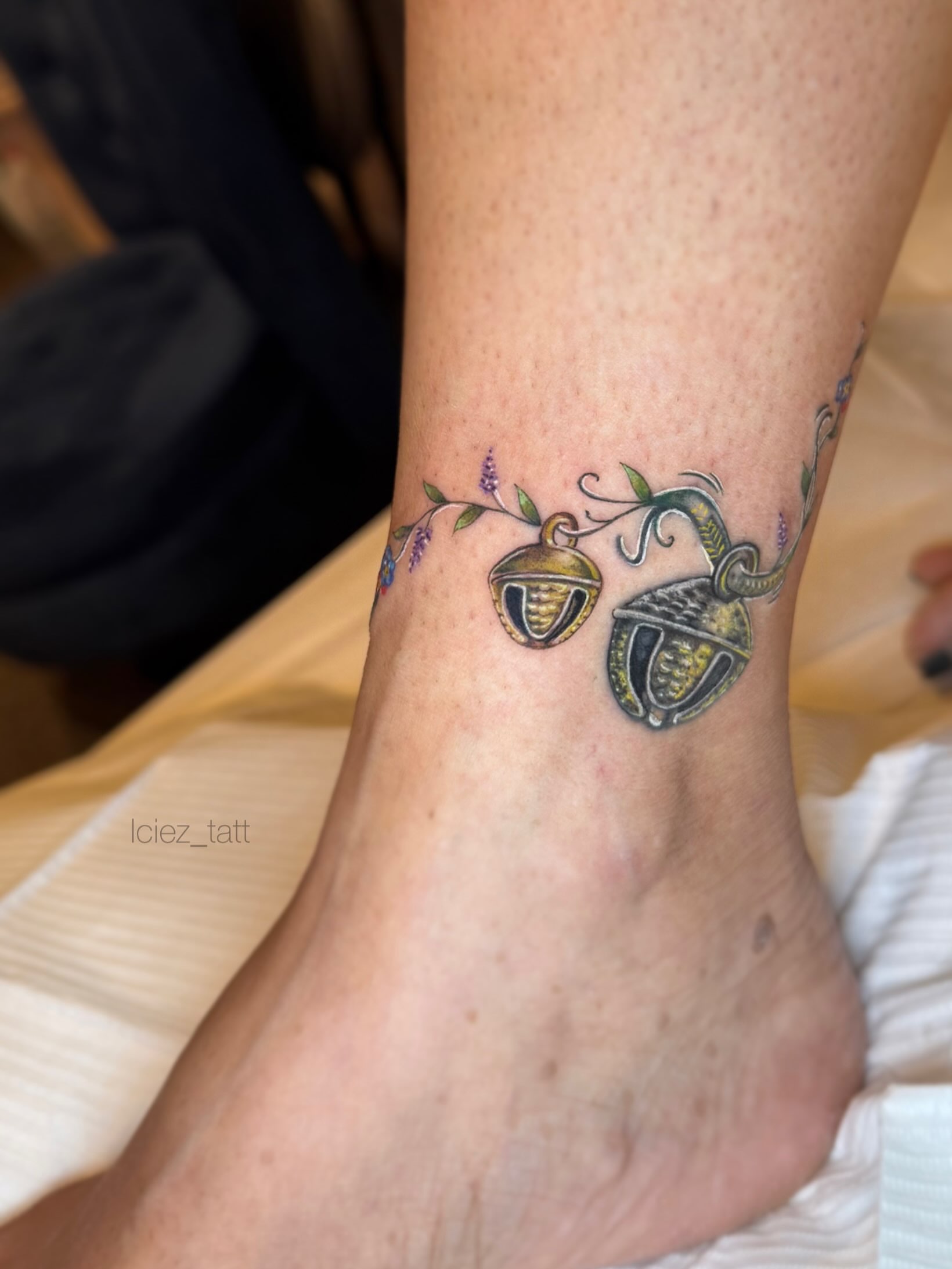 Bell and floral vine realism tattoo on the foot by Iciez