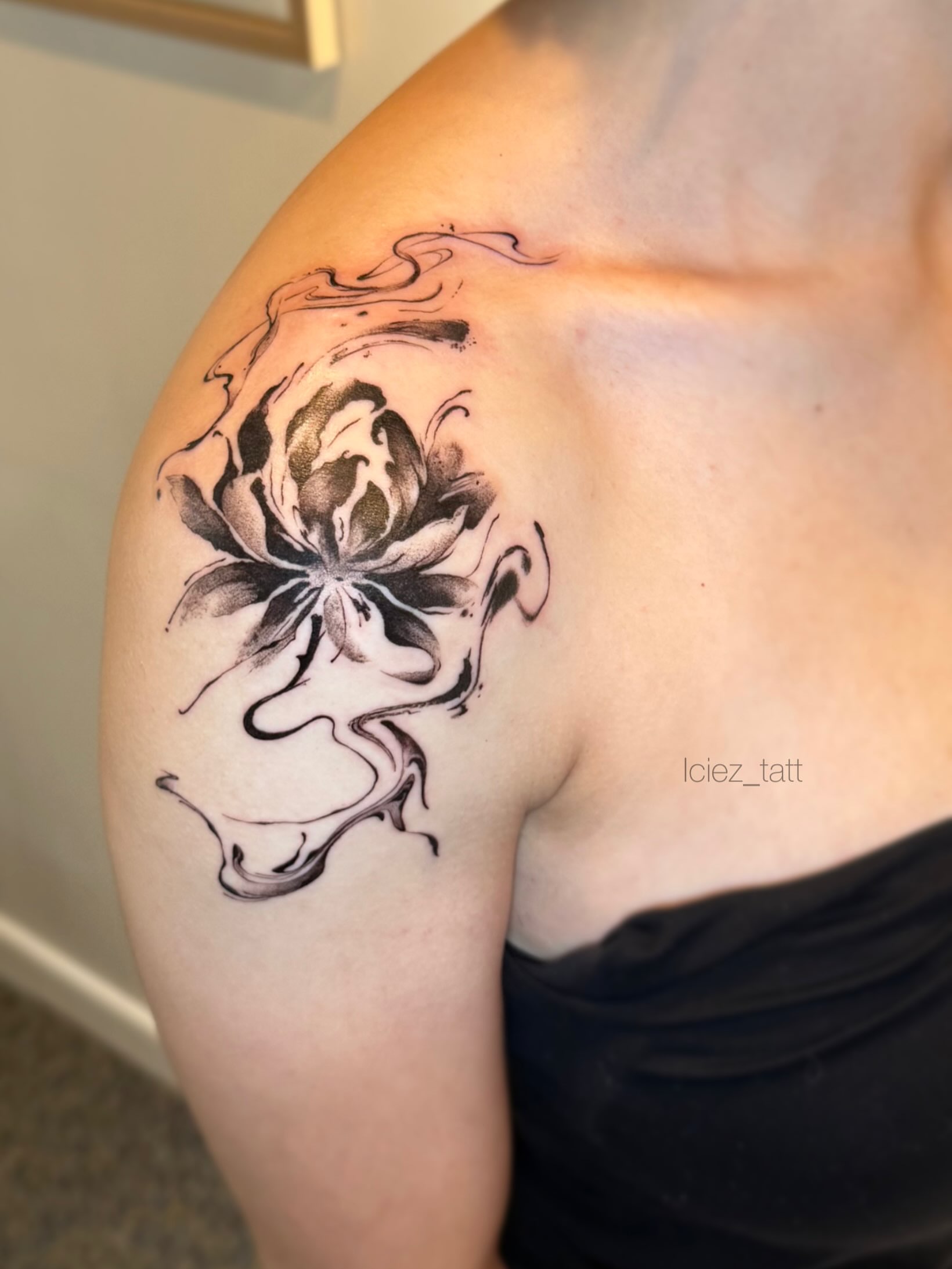Lotus flower black and grey tattoo on the shoulder by Iciez