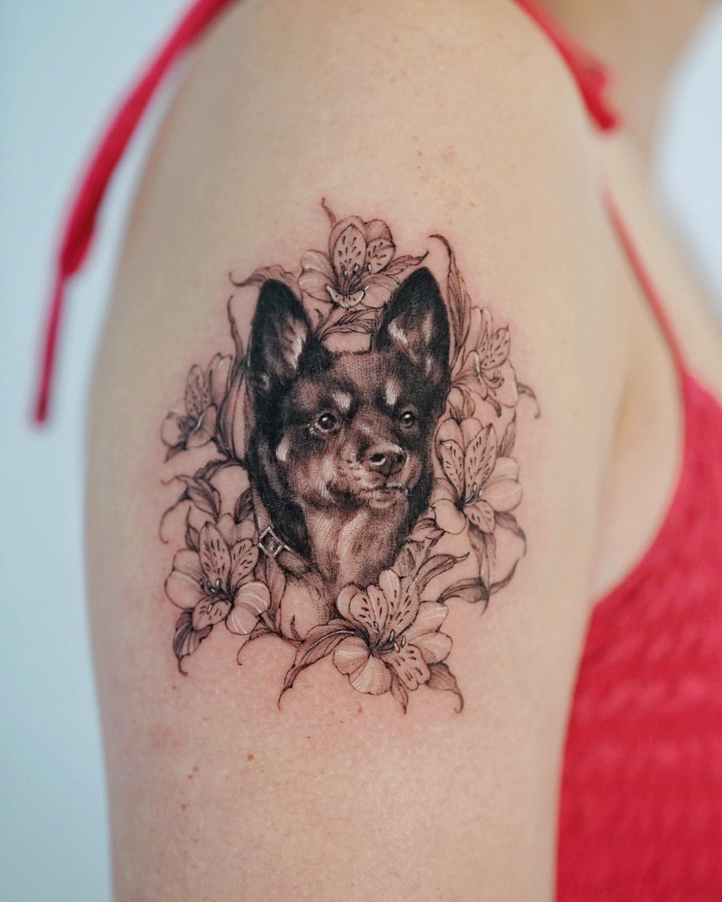 Dog with flowers realism tattoo on the shoulder by Lily, Los Angeles, California