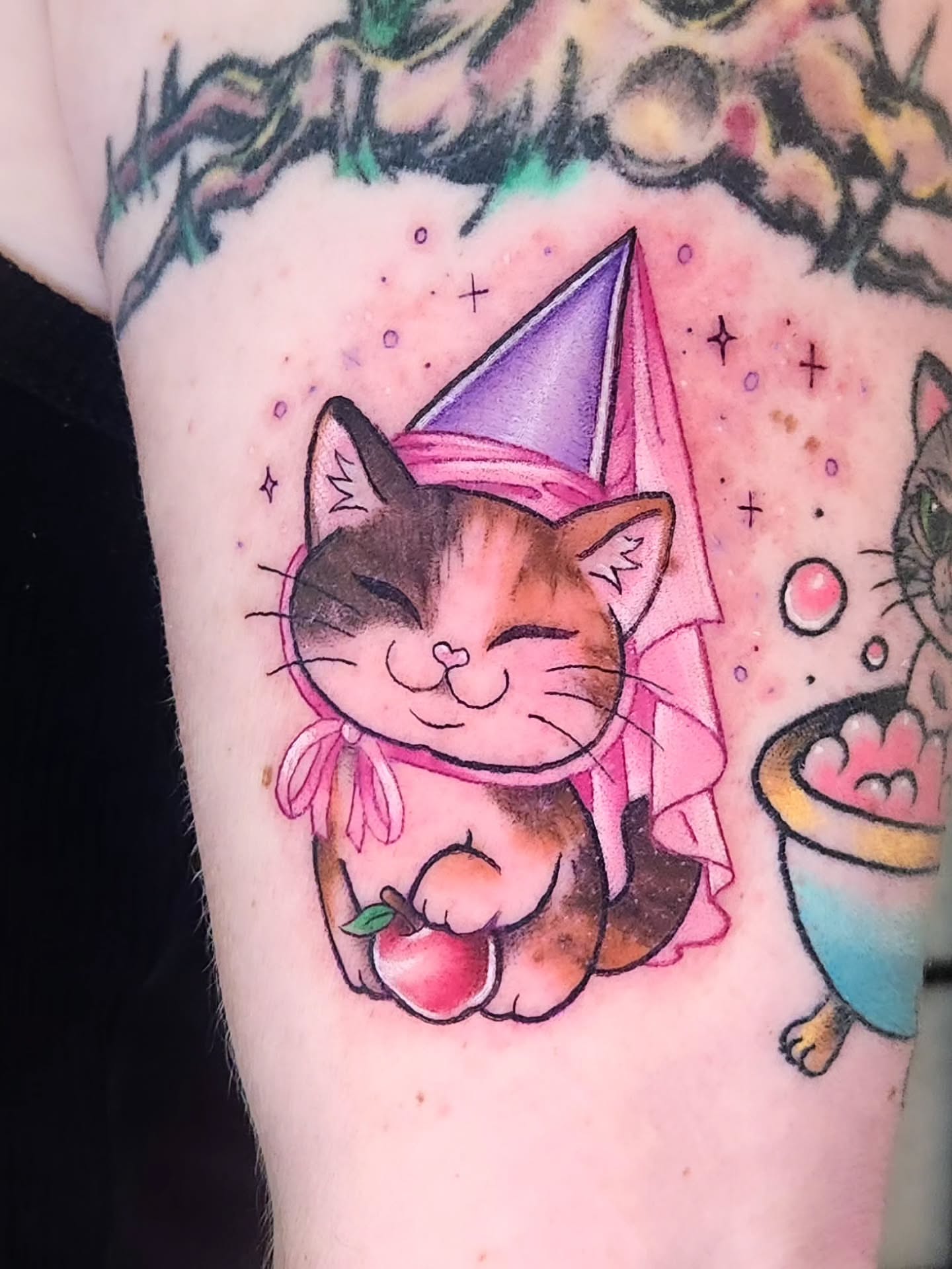 Cat wearing party hat new school tattoo on the forearm by Amanda Boyd - Duh!