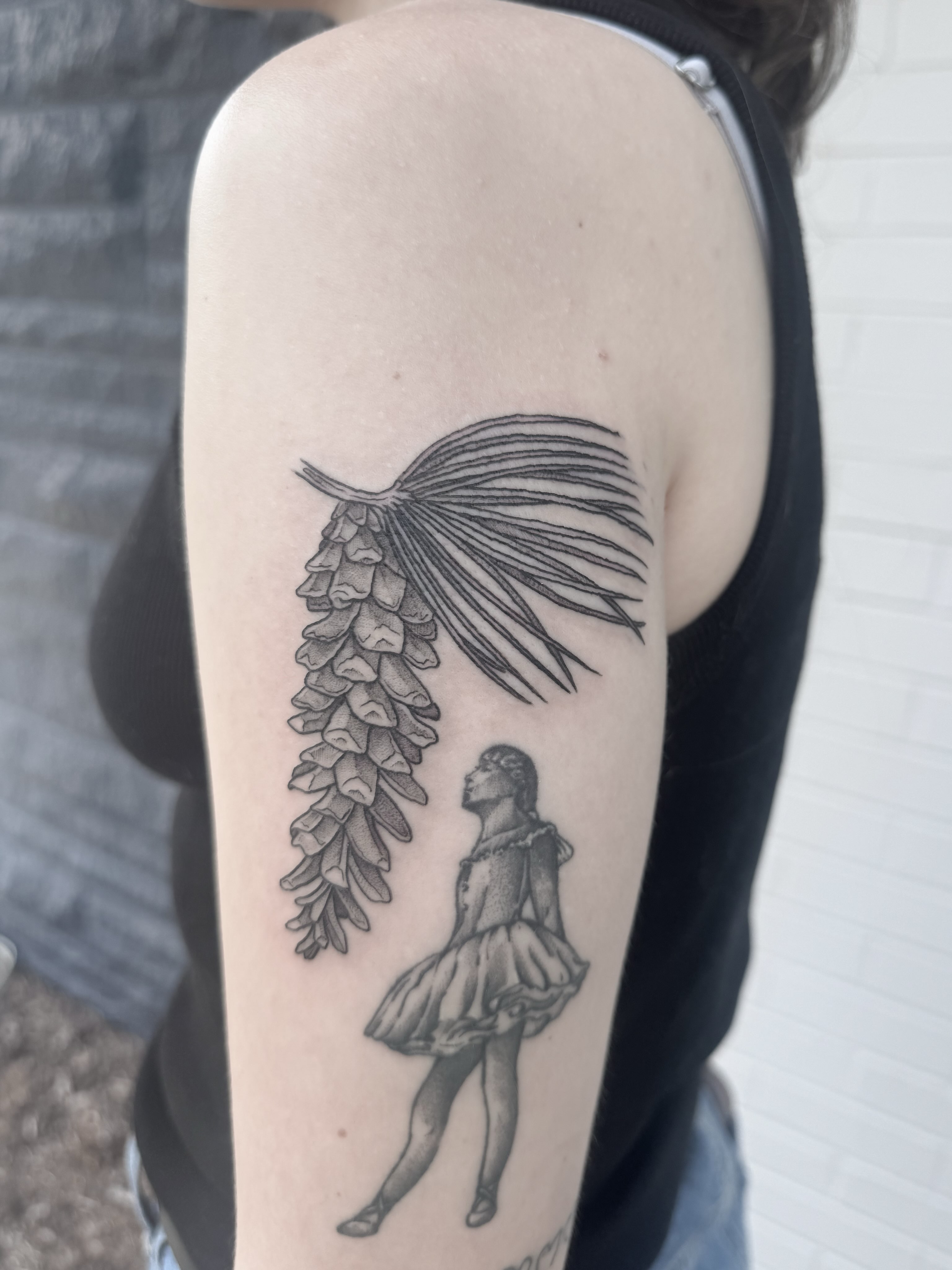 Foxglove and dancer black and grey tattoo on the upper arm by Audrey Kacel, Holland, Michigan