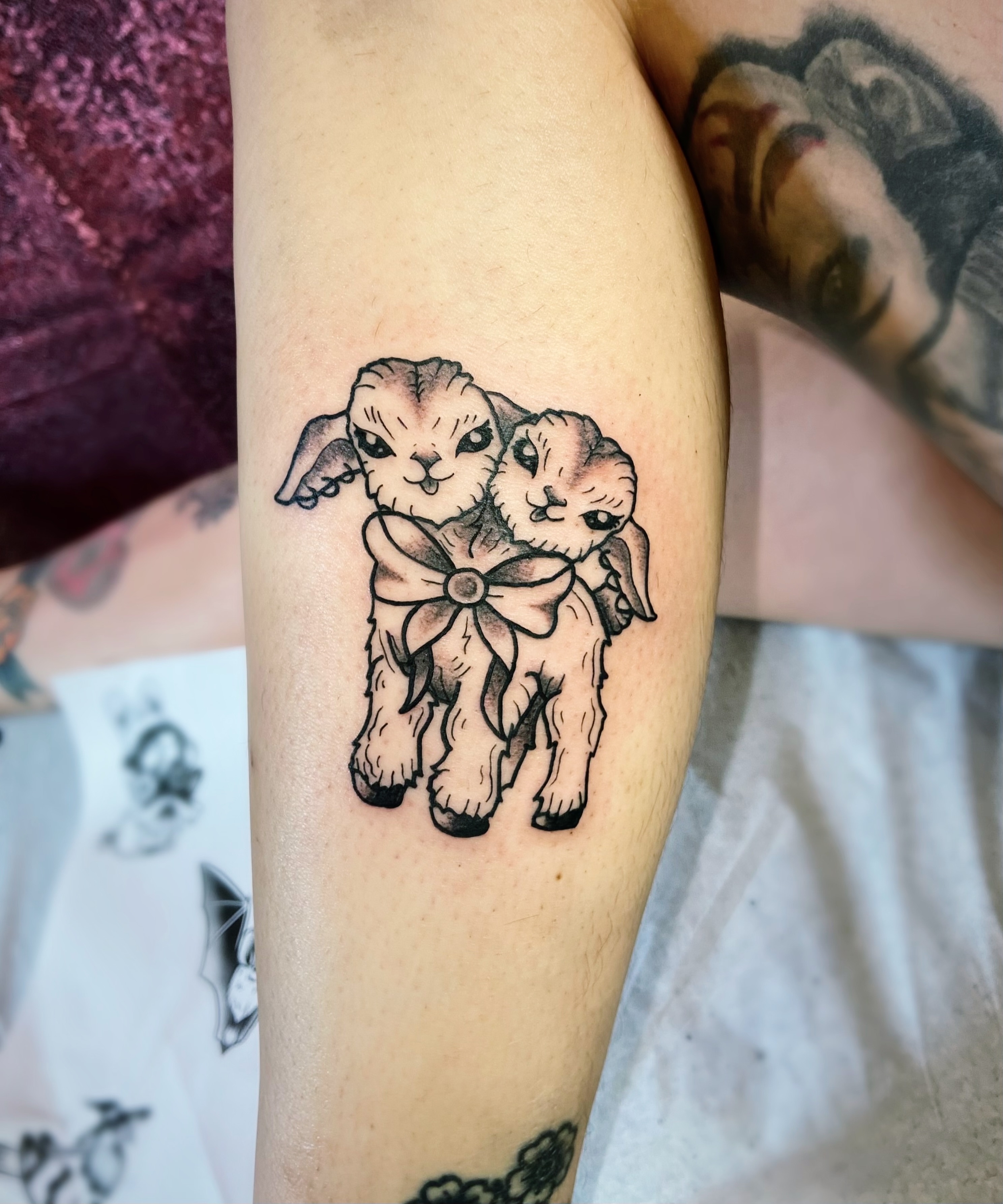 Two bunnies black and grey tattoo on the forearm by Shay Cole
