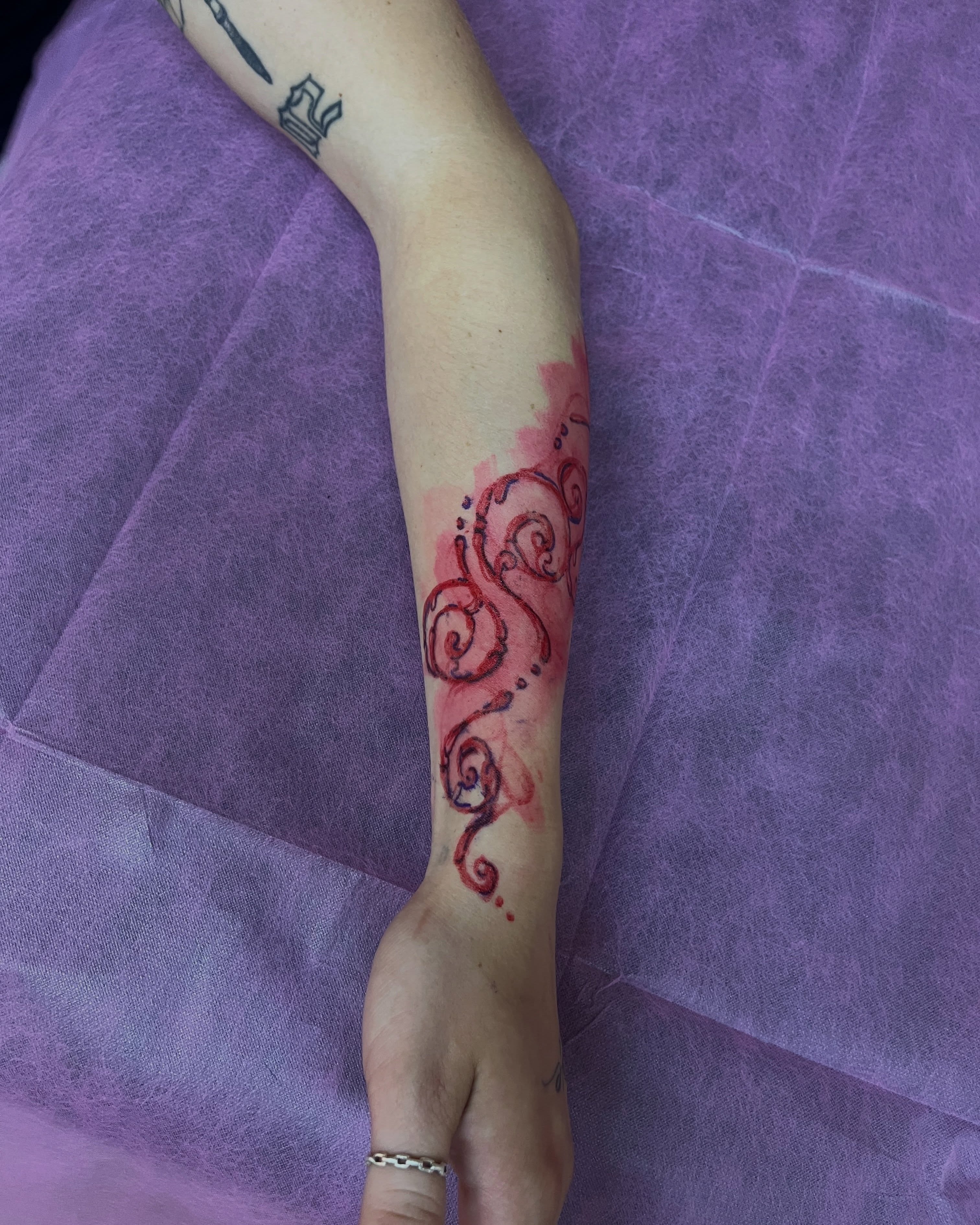Swirls watercolor tattoo on the forearm by mia