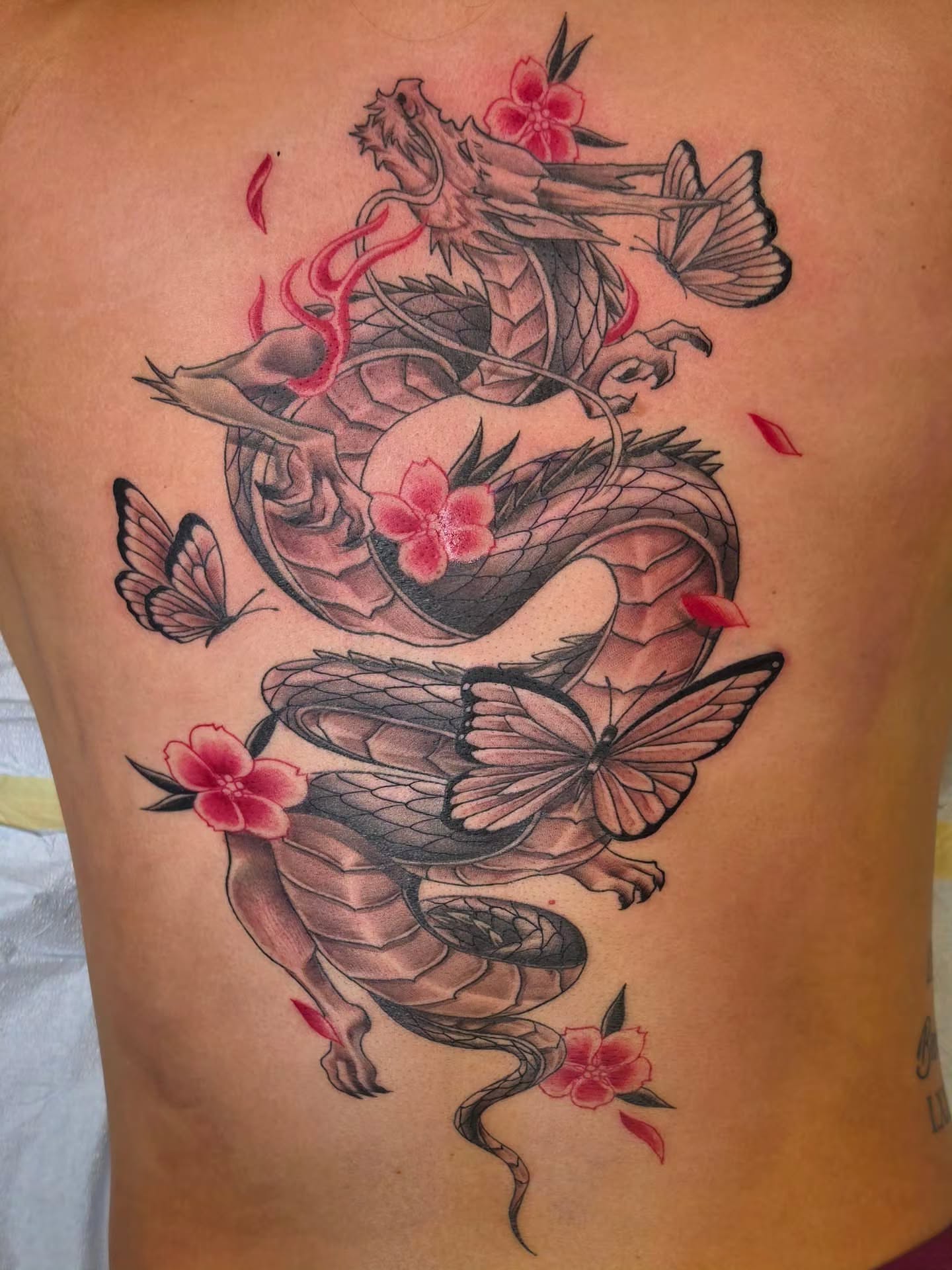 Dragon and cherry blossoms japanese irezumi tattoo on the ribs by Anthony Moncada