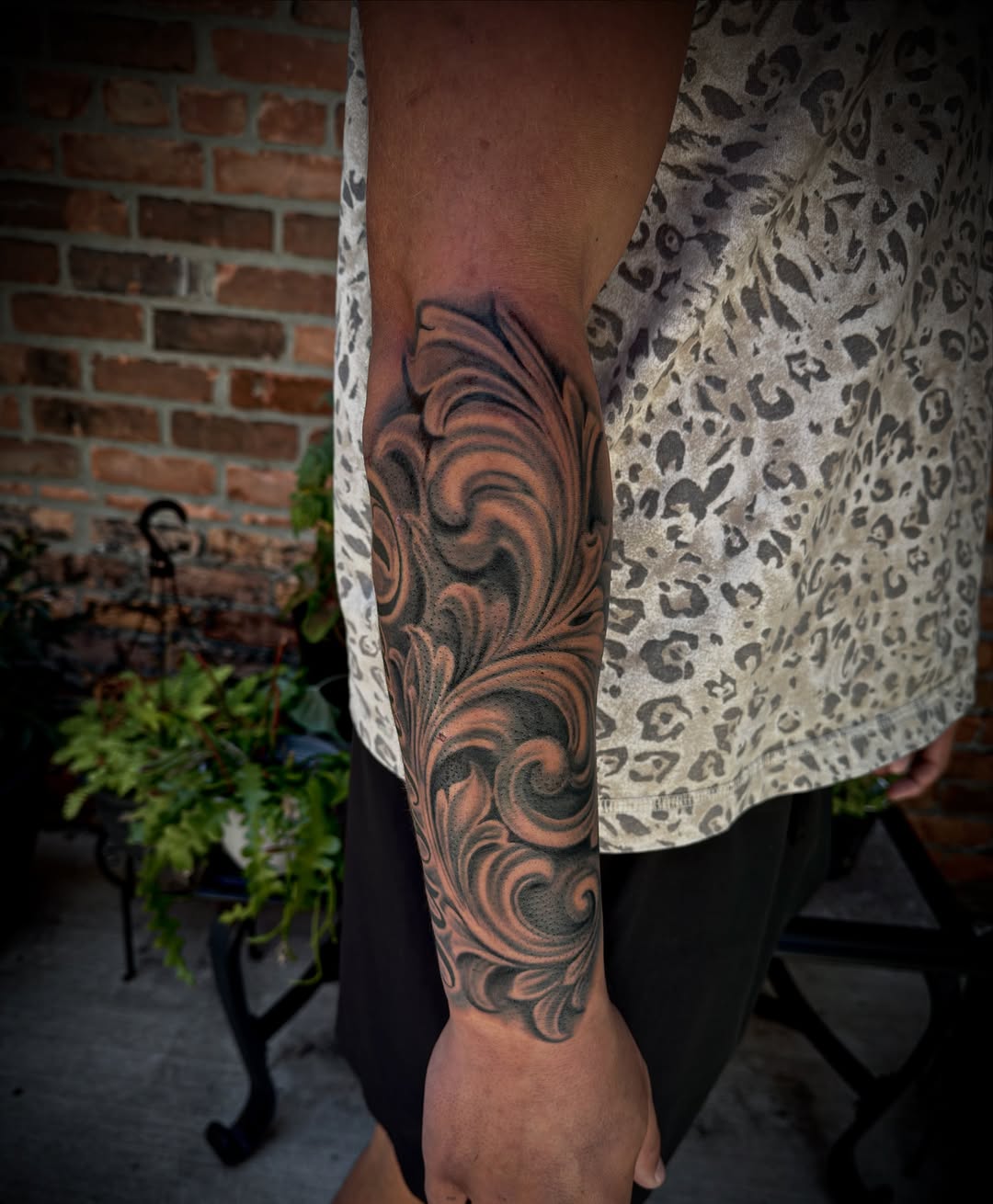 Ornamental scrollwork Chicano tattoo on the forearm by Kodi Klo