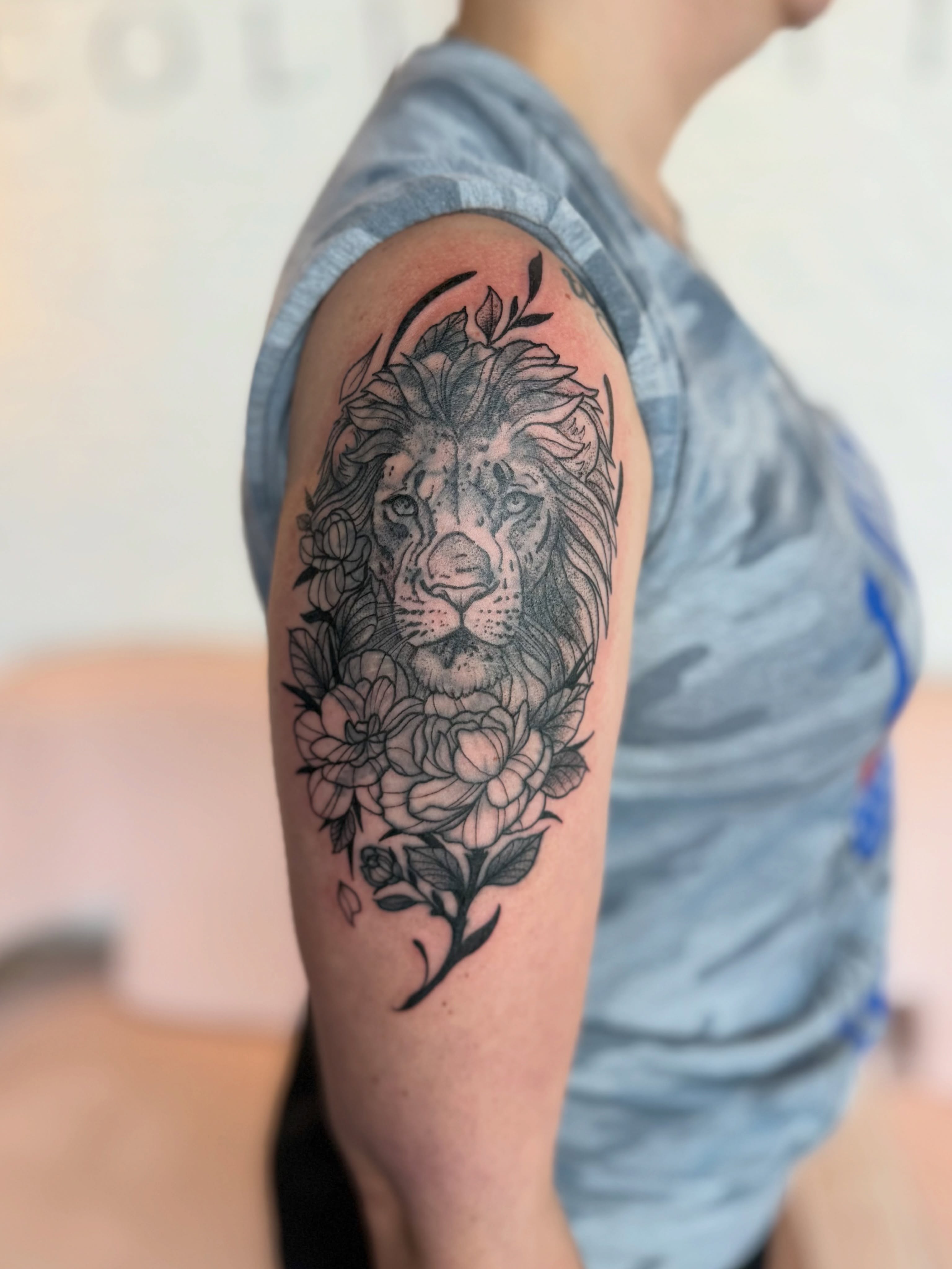 Lion and flowers realism tattoo on the forearm by Kyndall Lynn, Waxahachie, Texas