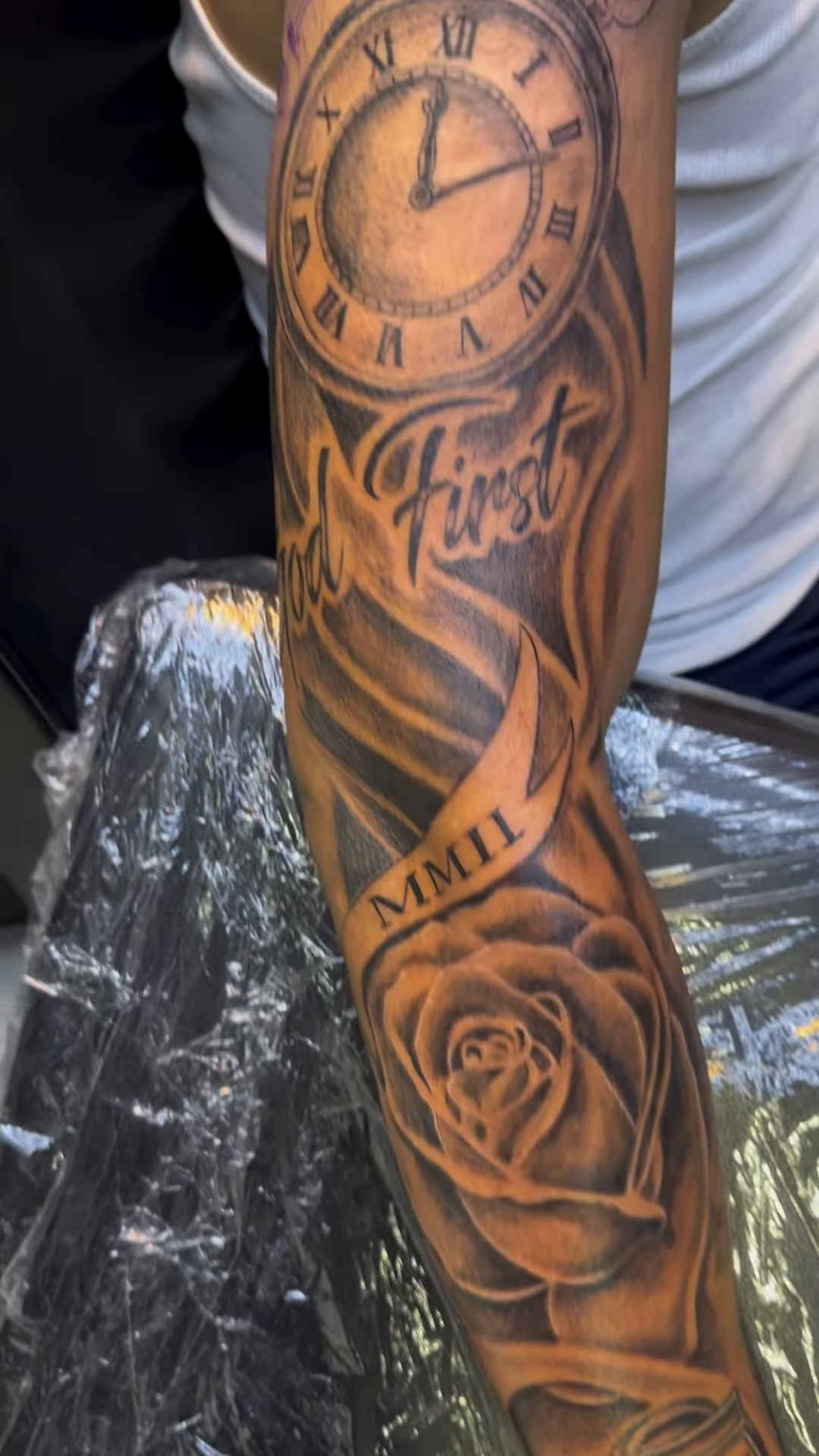 Clock and rose Chicano tattoo on the upper arm by Jose Onasis Disla, New York, New York
