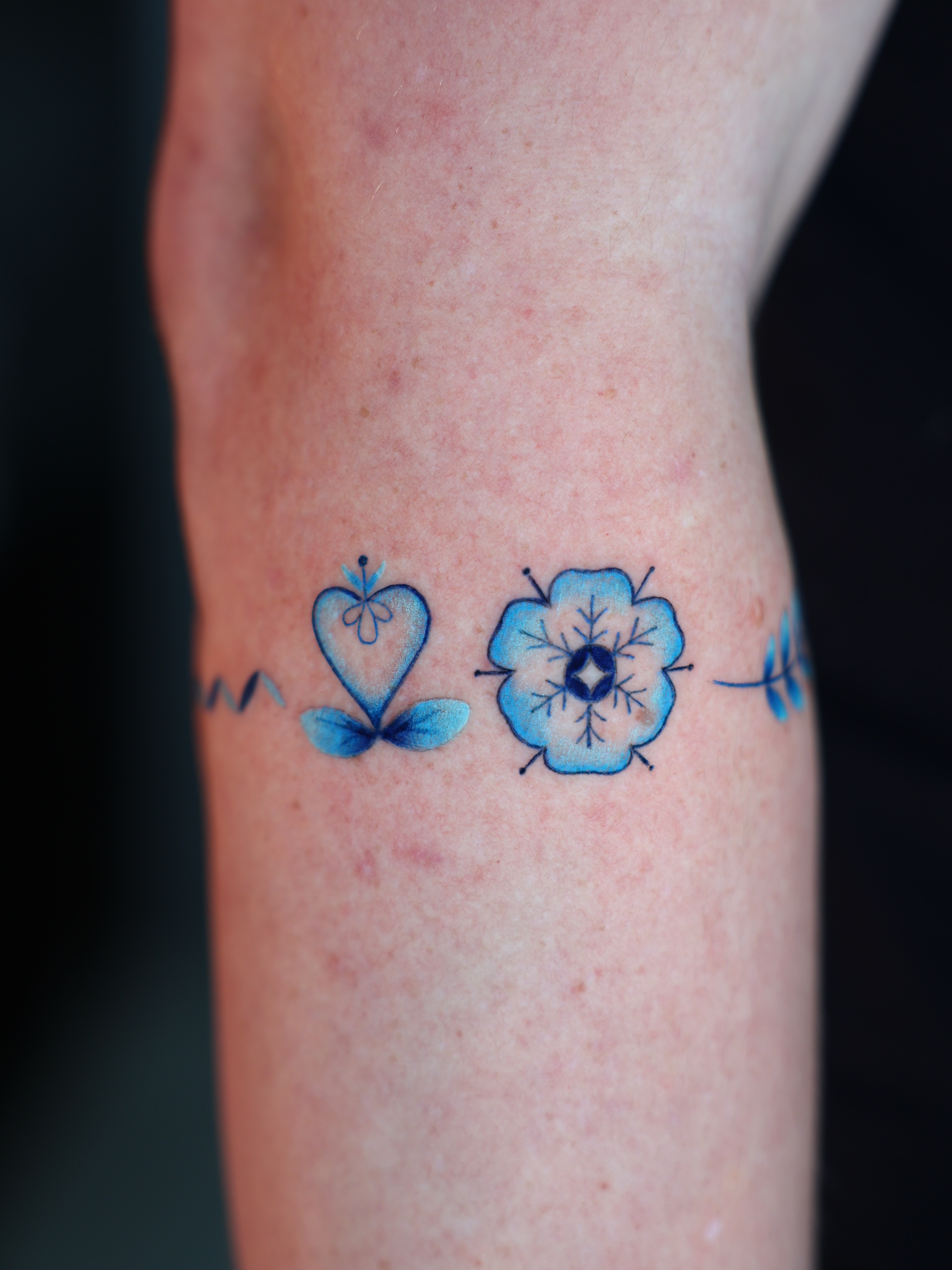 Blue butterfly and flower watercolor tattoo on the forearm by Hannah Burnside, Charlotte, North Carolina
