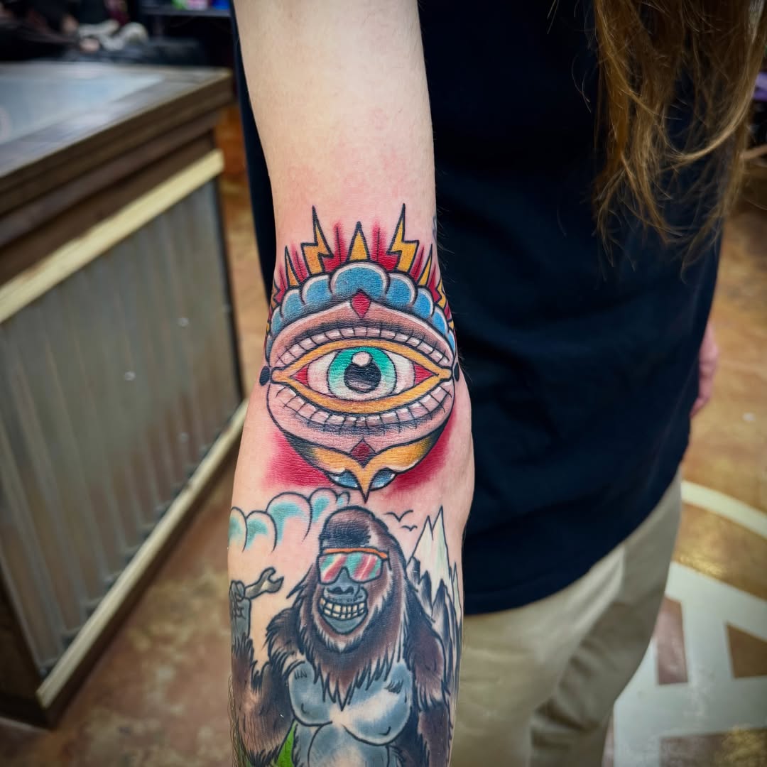 Eye and gorilla American traditional tattoo on the forearm by David C. McGhee