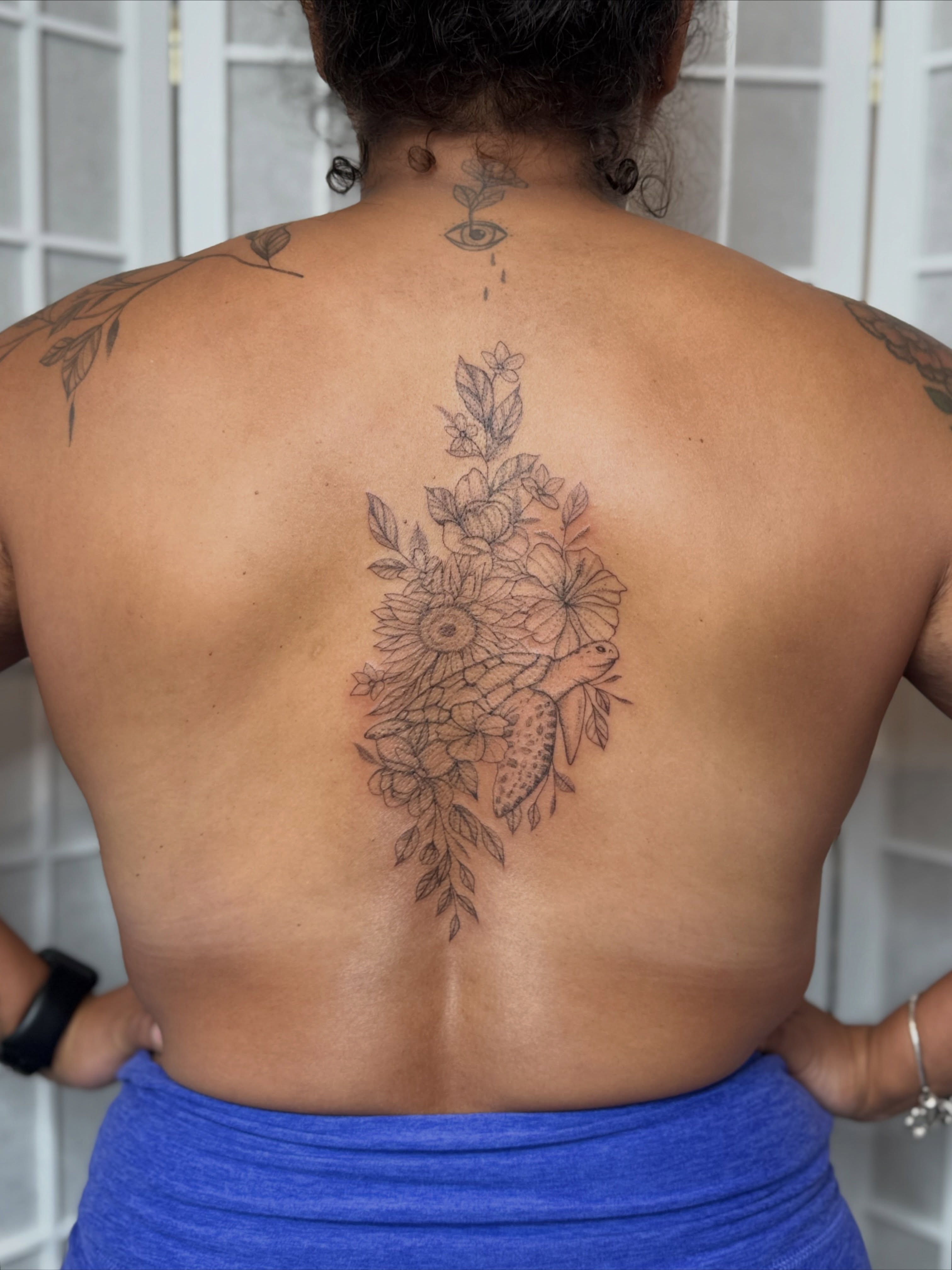 Sunflower and turtle black and grey tattoo on the back by Dama