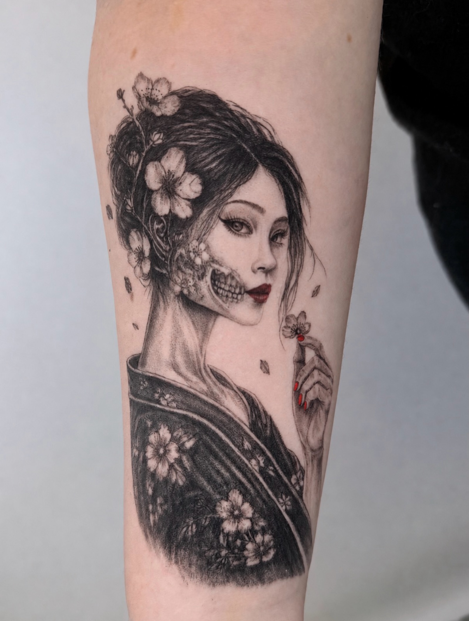 Geisha with cherry blossoms realism tattoo on the forearm by Yuri Chloe Ngo Tattoo Artist