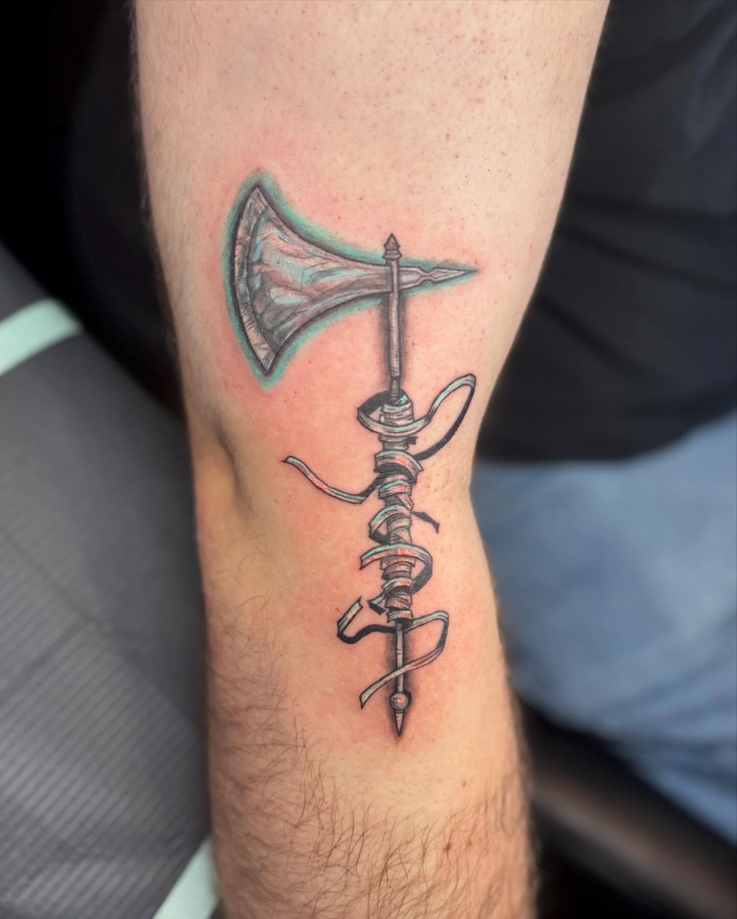 Ax and rope black and grey tattoo on the forearm by Nina Rush