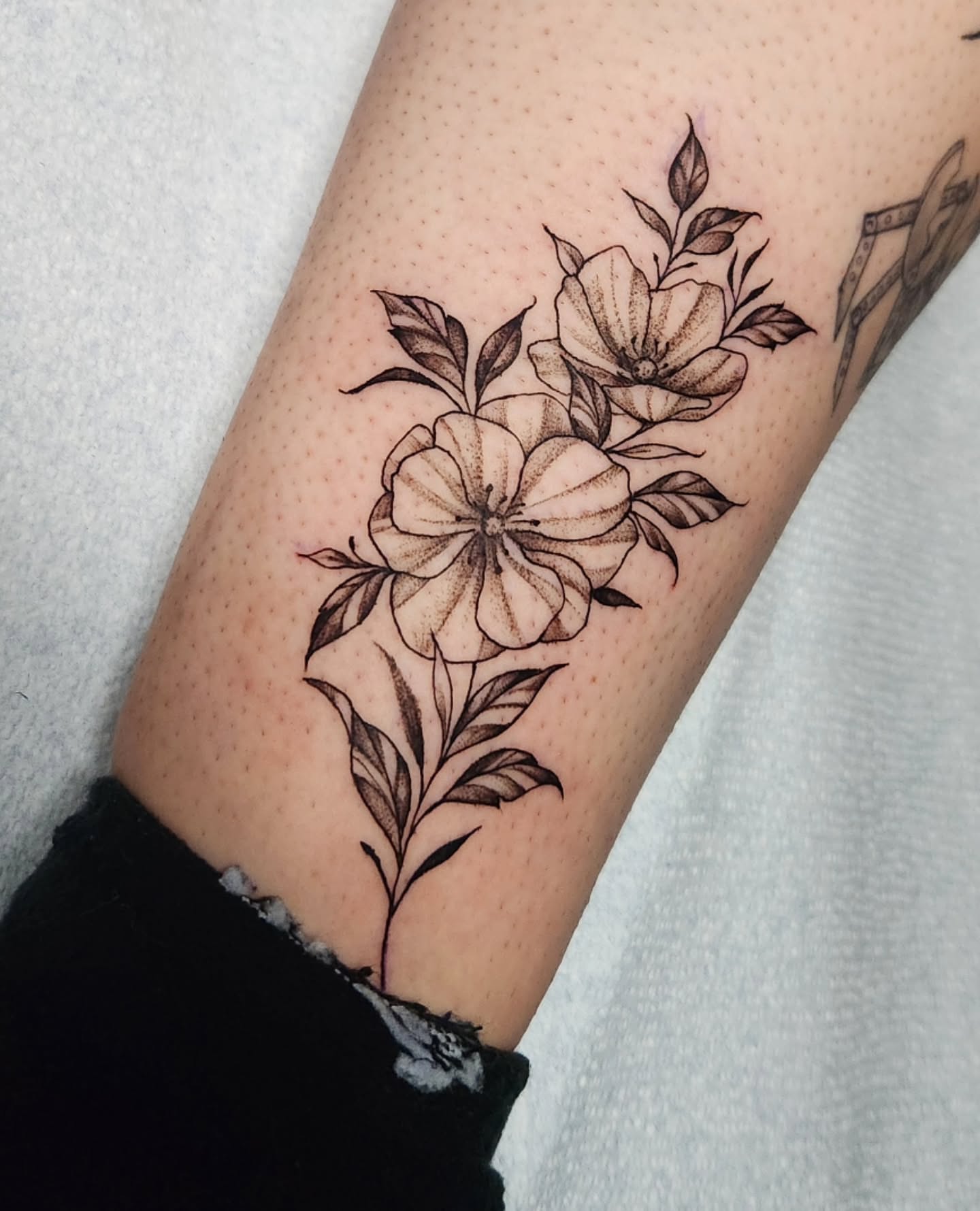 Floral bouquet black and grey tattoo on the forearm by Abby Renteria