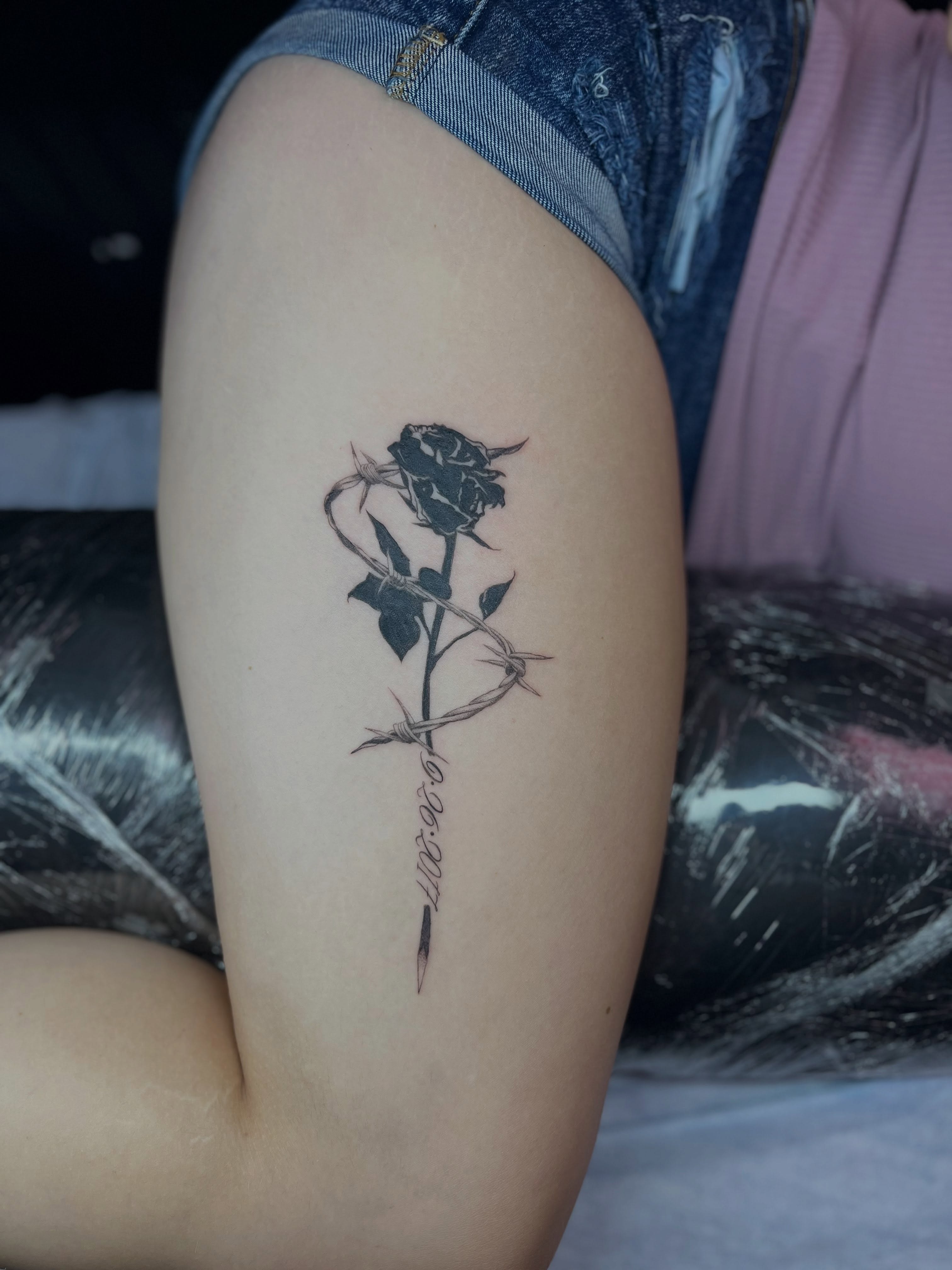 Rose with barbed wire realism tattoo on the thigh by Caitlin, Richmond, Virginia