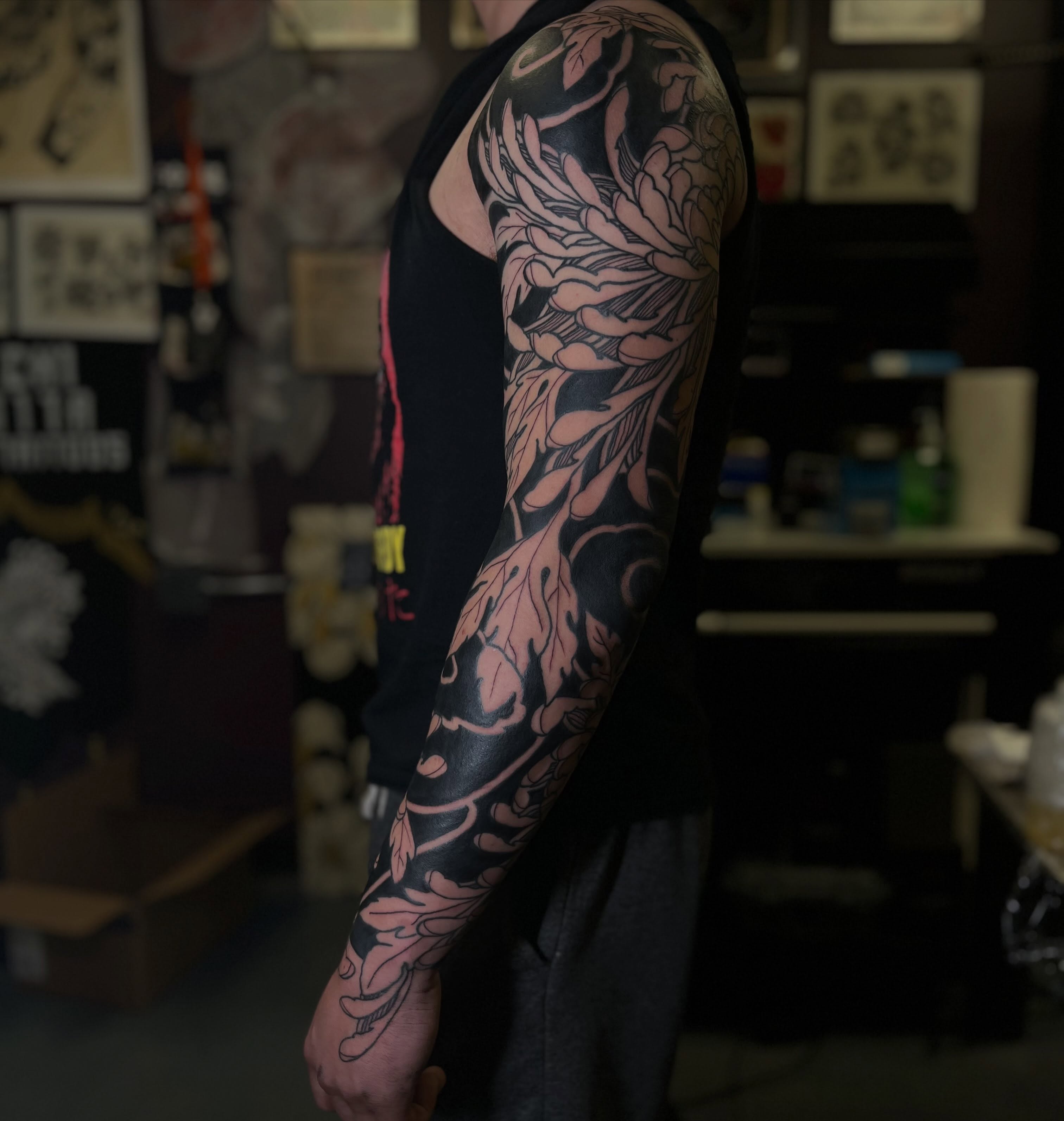 Floral design black and grey tattoo on the upper arm by Kaichi Fujita, Eugene, Oregon