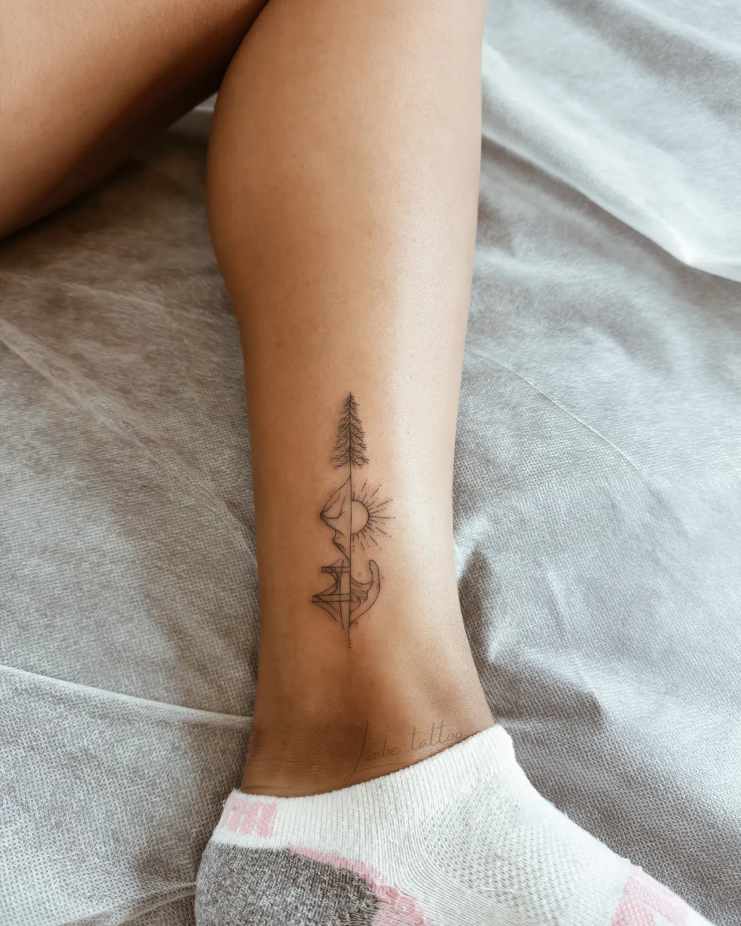 Tree and sun geometric tattoo on the calf by Floral Fineline Tattoo
