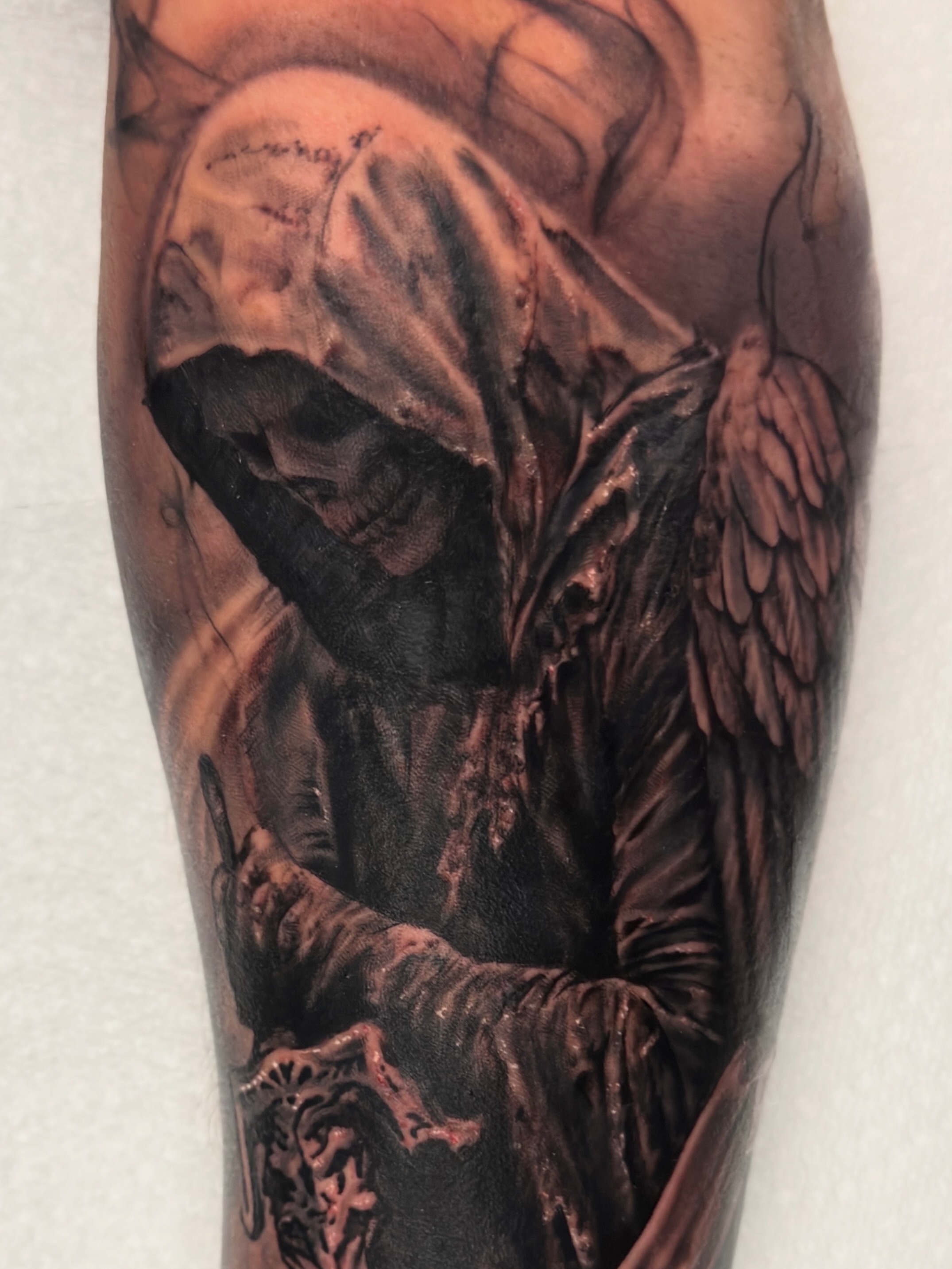 Grim reaper dark realism tattoo on the forearm by Justin Hay