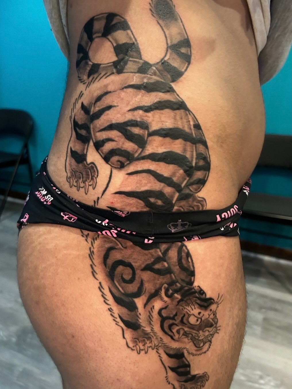 Tiger black and grey tattoo on the thigh by Tattoos by Fesik LLC