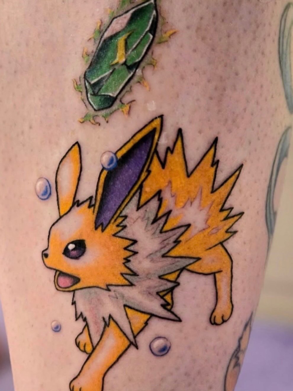 Jolteon anime tattoo on the forearm by Tattoos by Fesik LLC