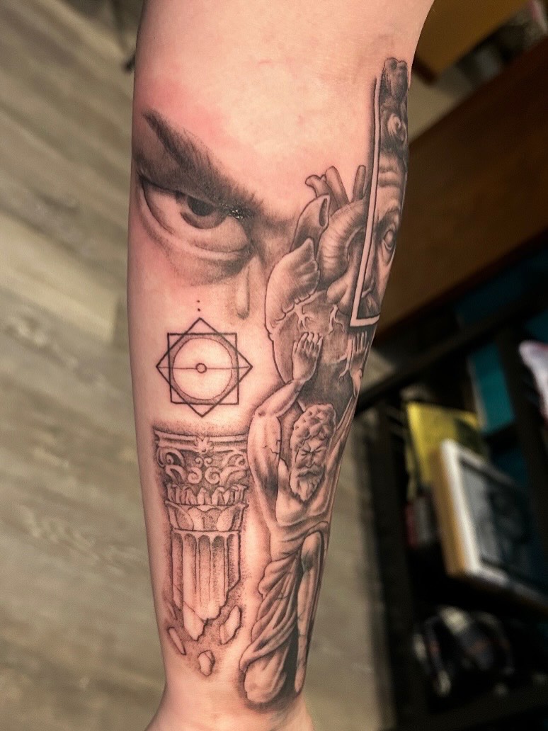 Statue and geometric symbol realism tattoo on the forearm by Tattoos by Fesik LLC