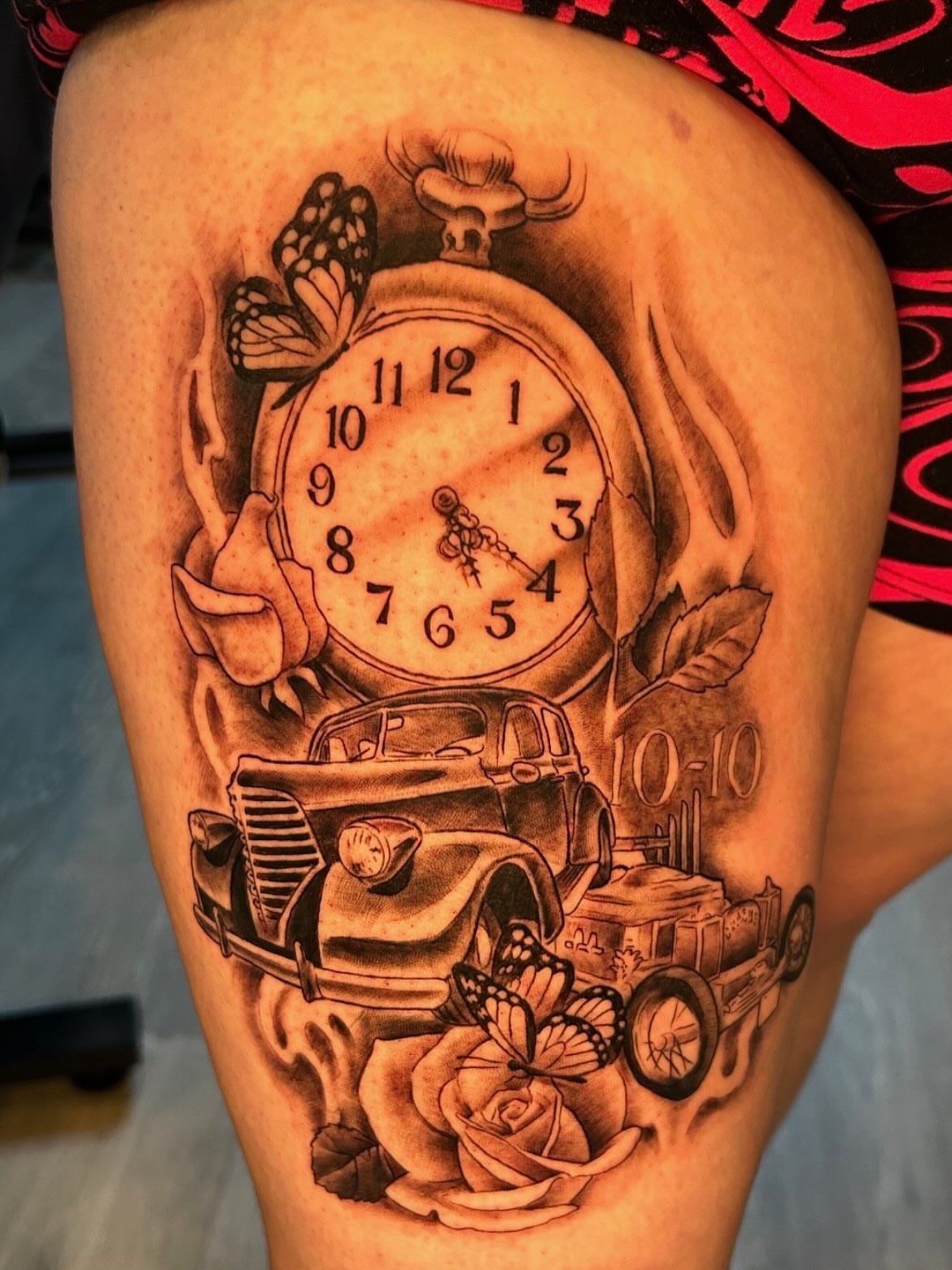 Clock and vintage car realism tattoo on the thigh by Tattoos by Fesik LLC
