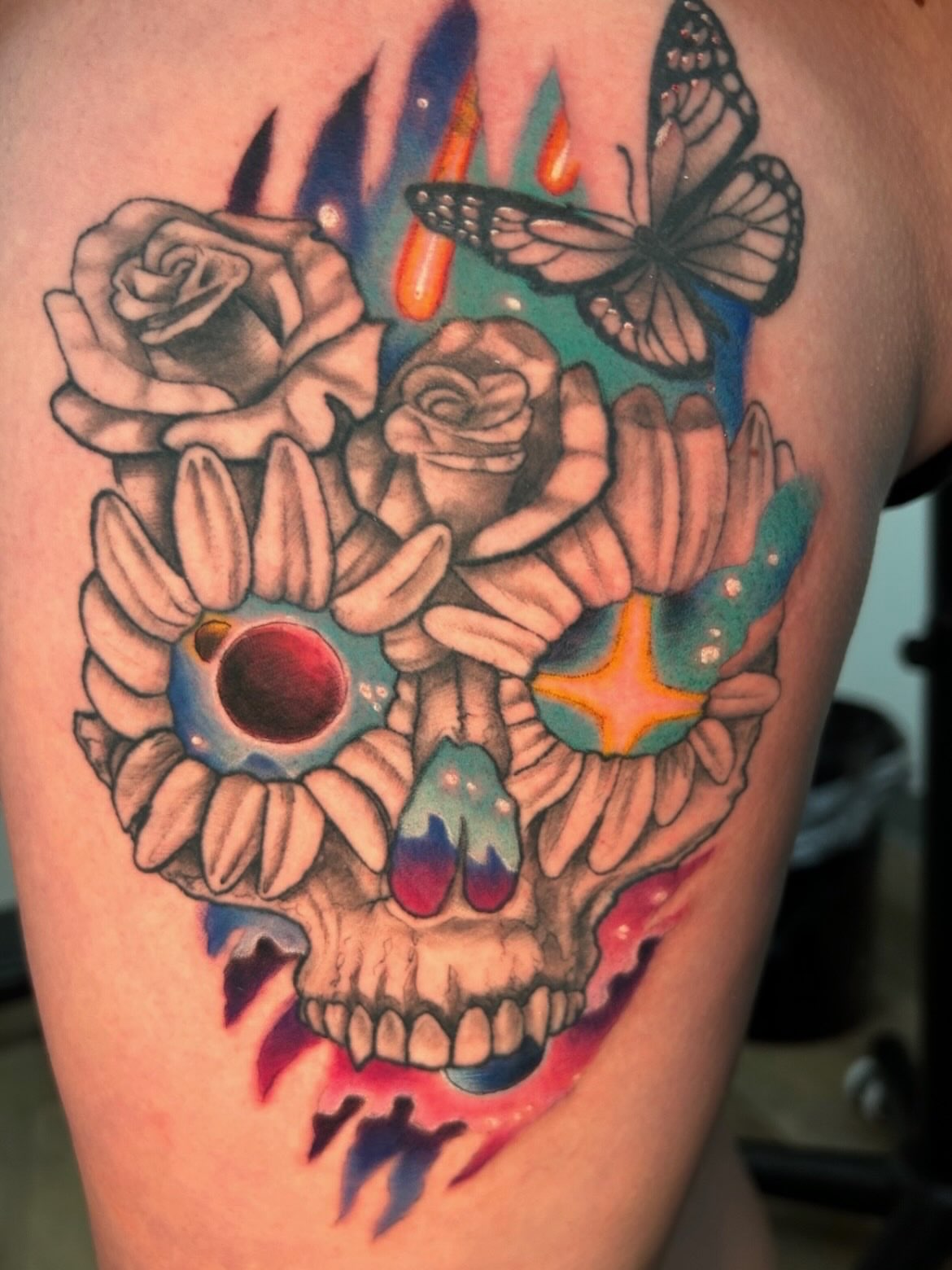 Skull with roses new school tattoo on the thigh by Tattoos by Fesik LLC