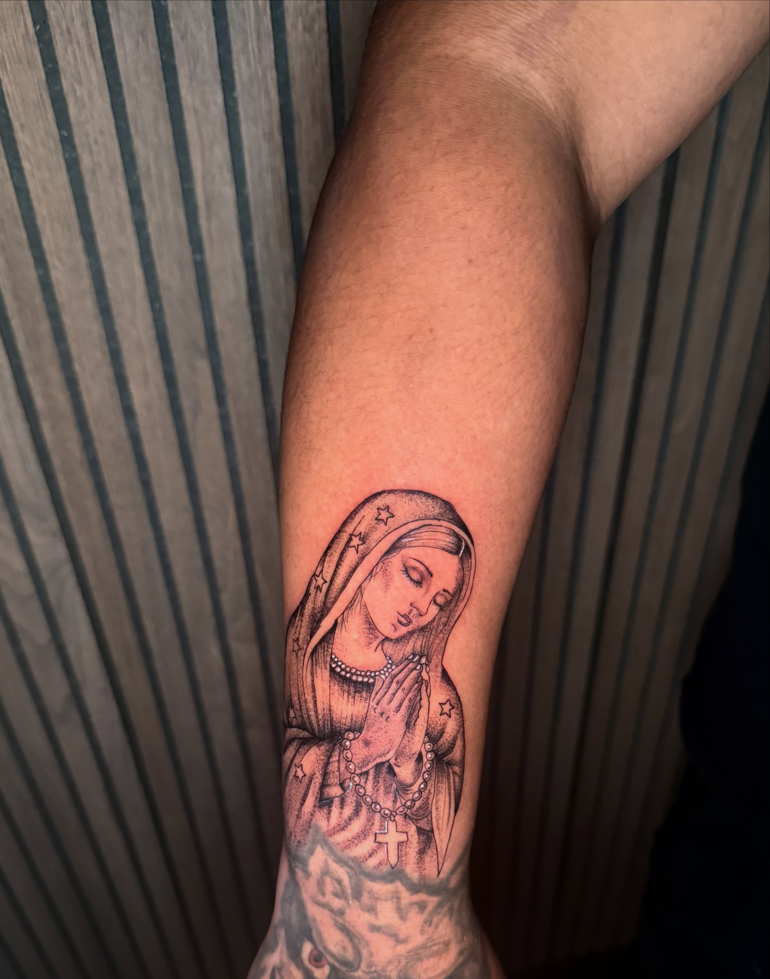 Religious figure praying realism tattoo on the forearm by Sebastian martinez, Memphis, Tennessee