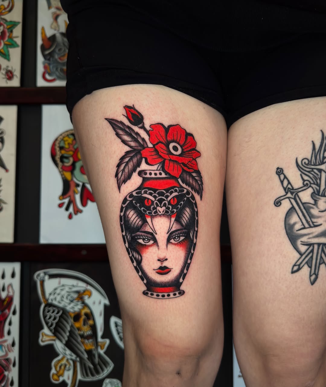 Woman's head with flower crown American traditional tattoo on the thigh by Allie Barringer
