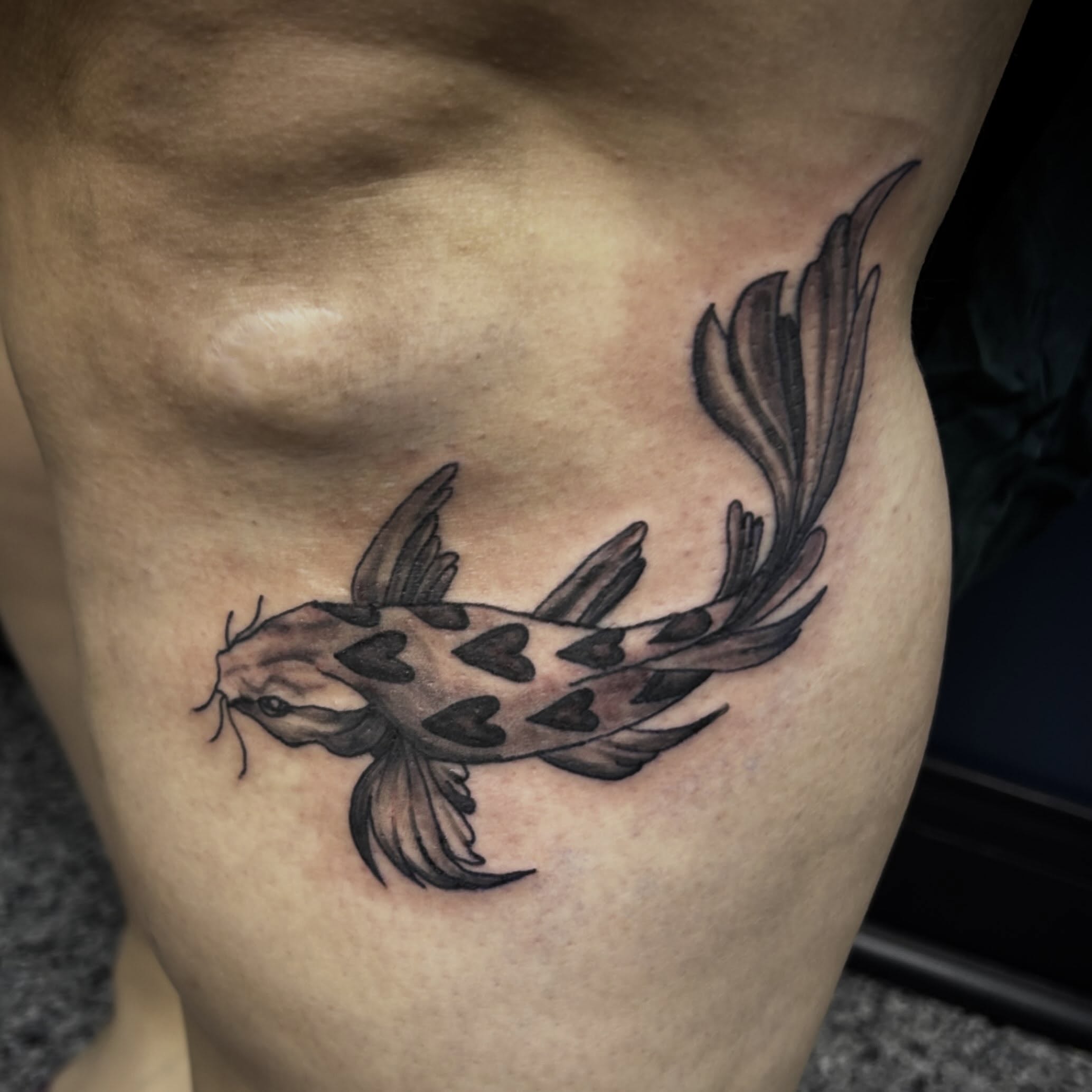 Koi fish black and grey tattoo on the thigh by Gillian