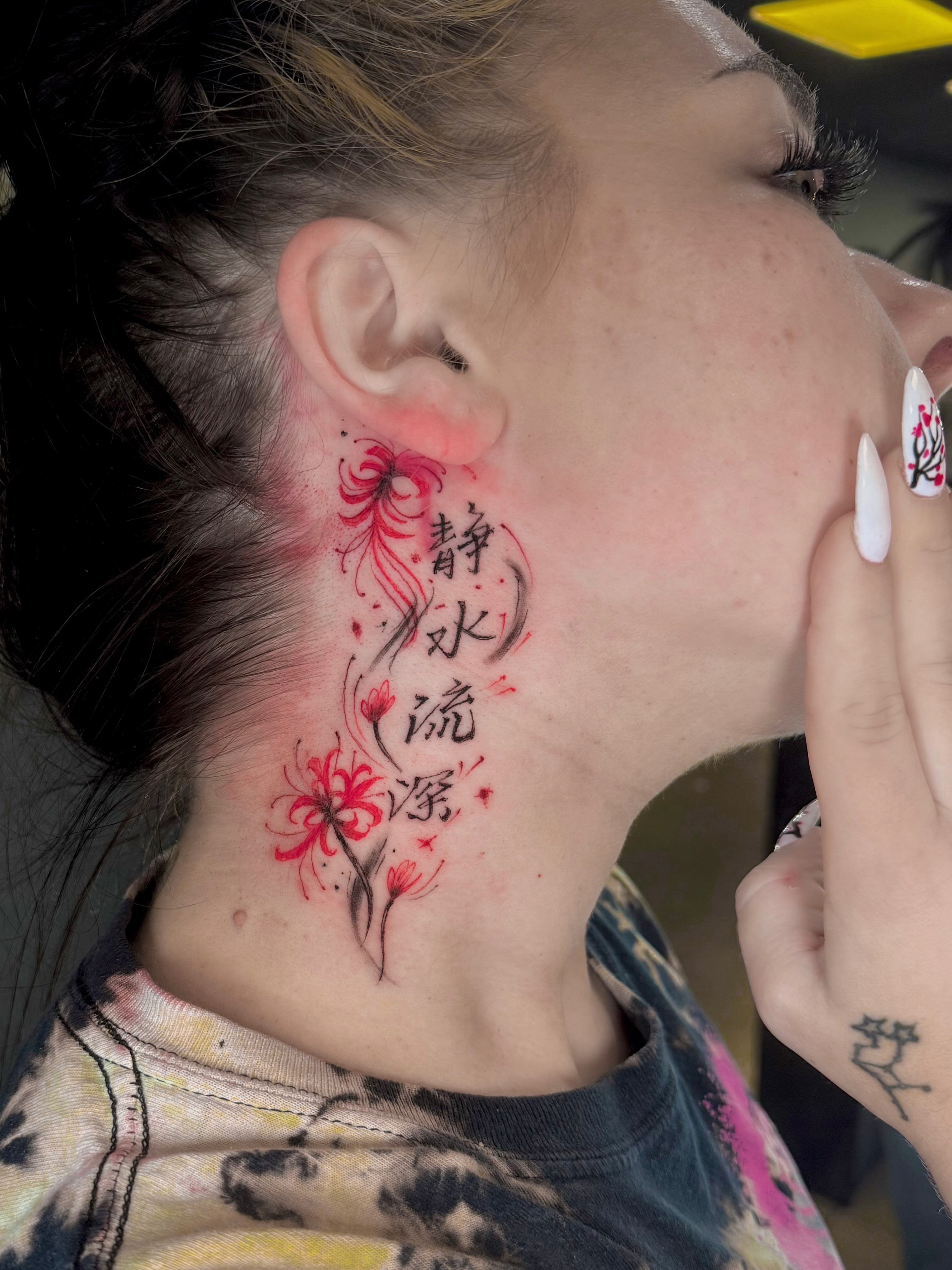 Chrysanthemum and Chinese characters dotwork tattoo on the neck by Stilow Memphis Tattoo Artist, Memphis, Tennessee