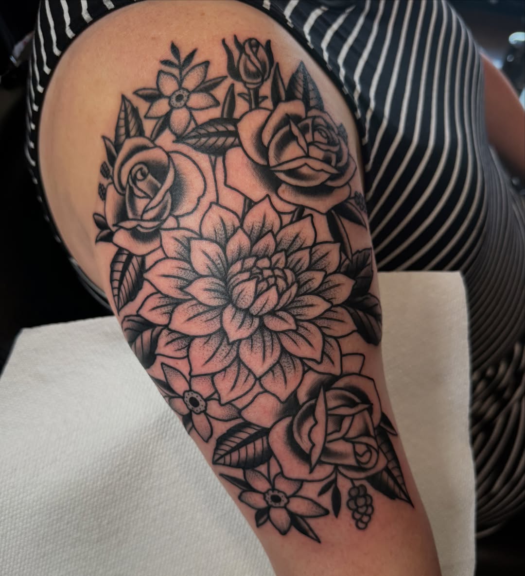 Floral bouquet black and grey tattoo on the forearm by Christopher Mikesell