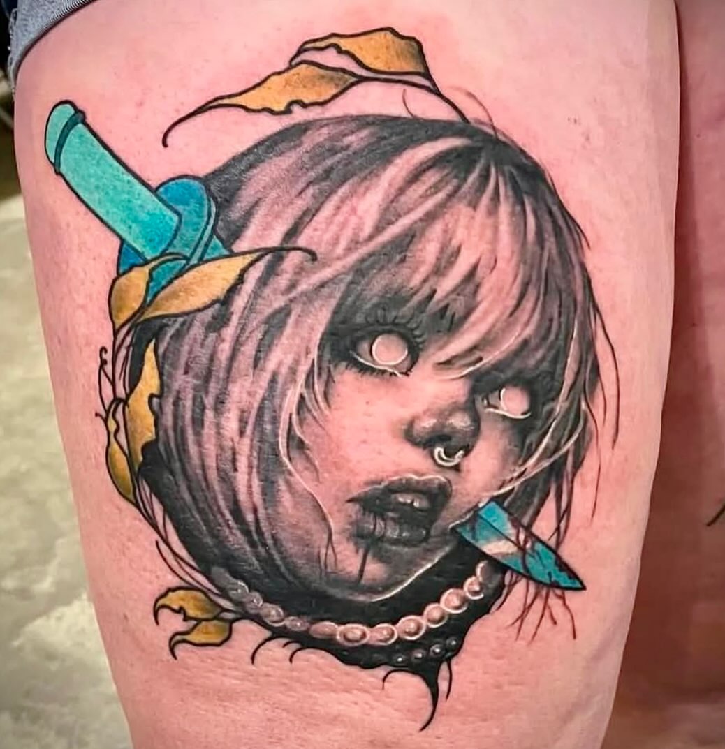 Doll head dark realism tattoo on the thigh by Anastasia Carrasco