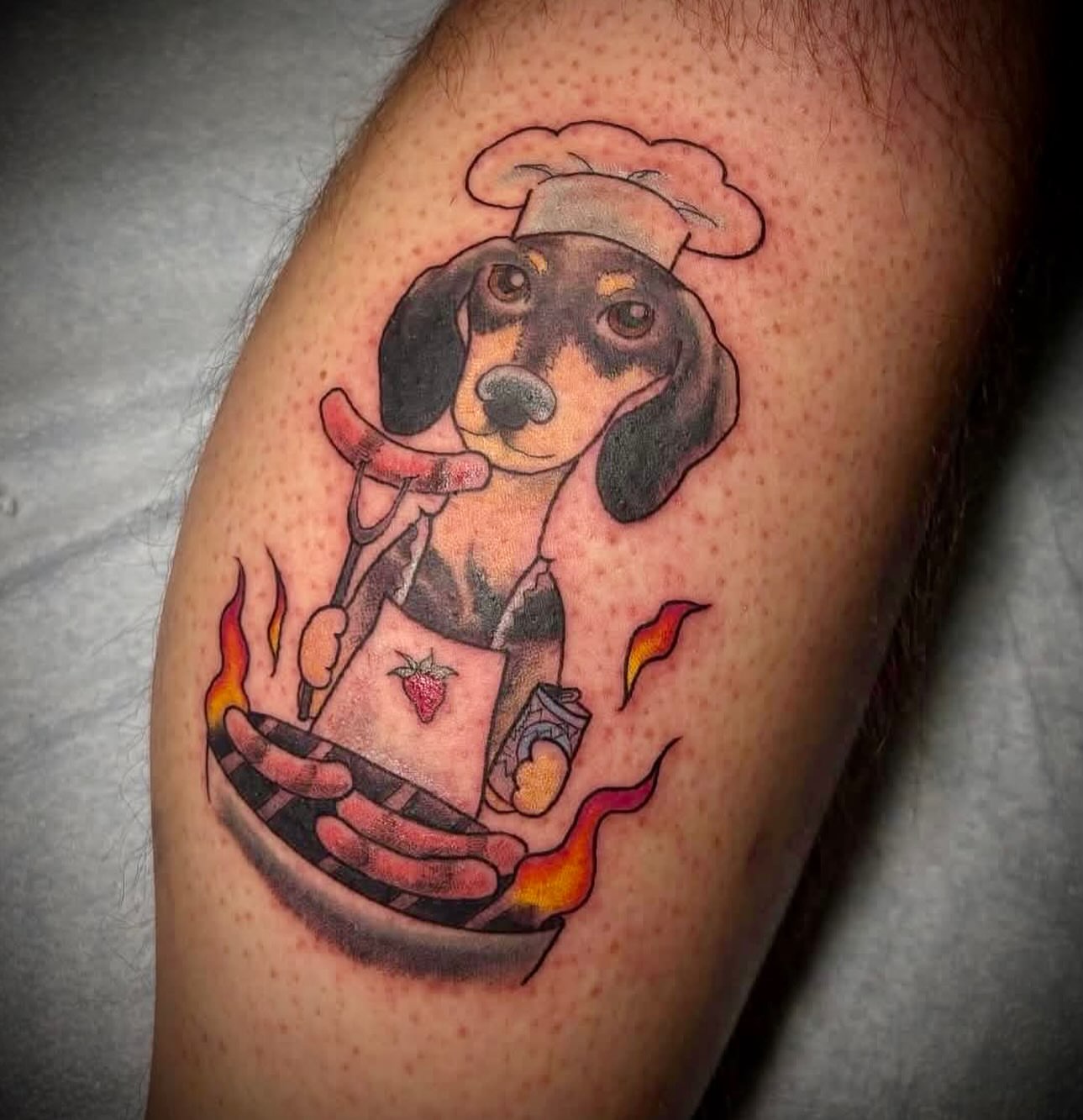 Dachshund chef American traditional tattoo on the forearm by Anastasia Carrasco