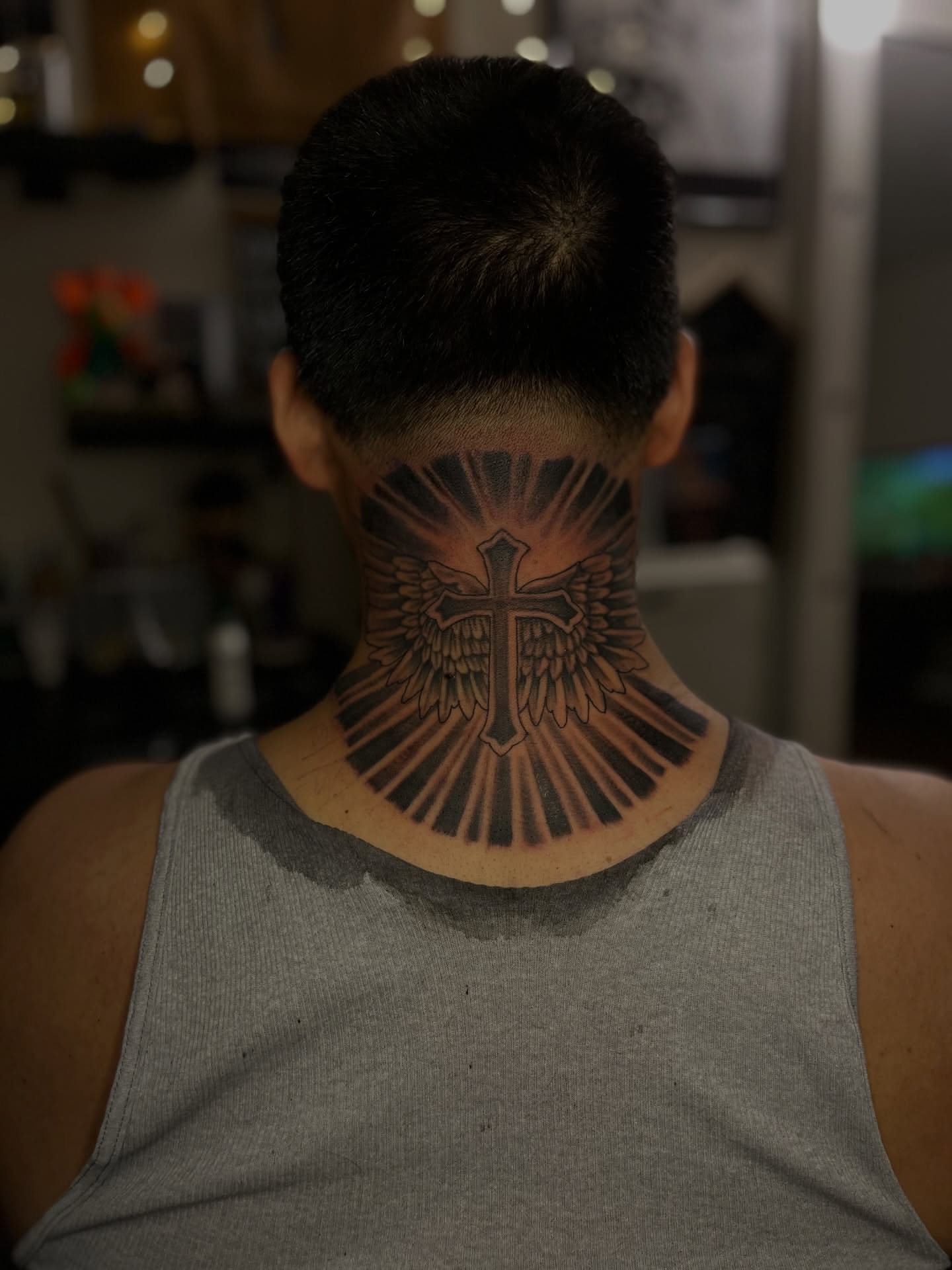 Cross with wings black and grey tattoo on the neck by Dee