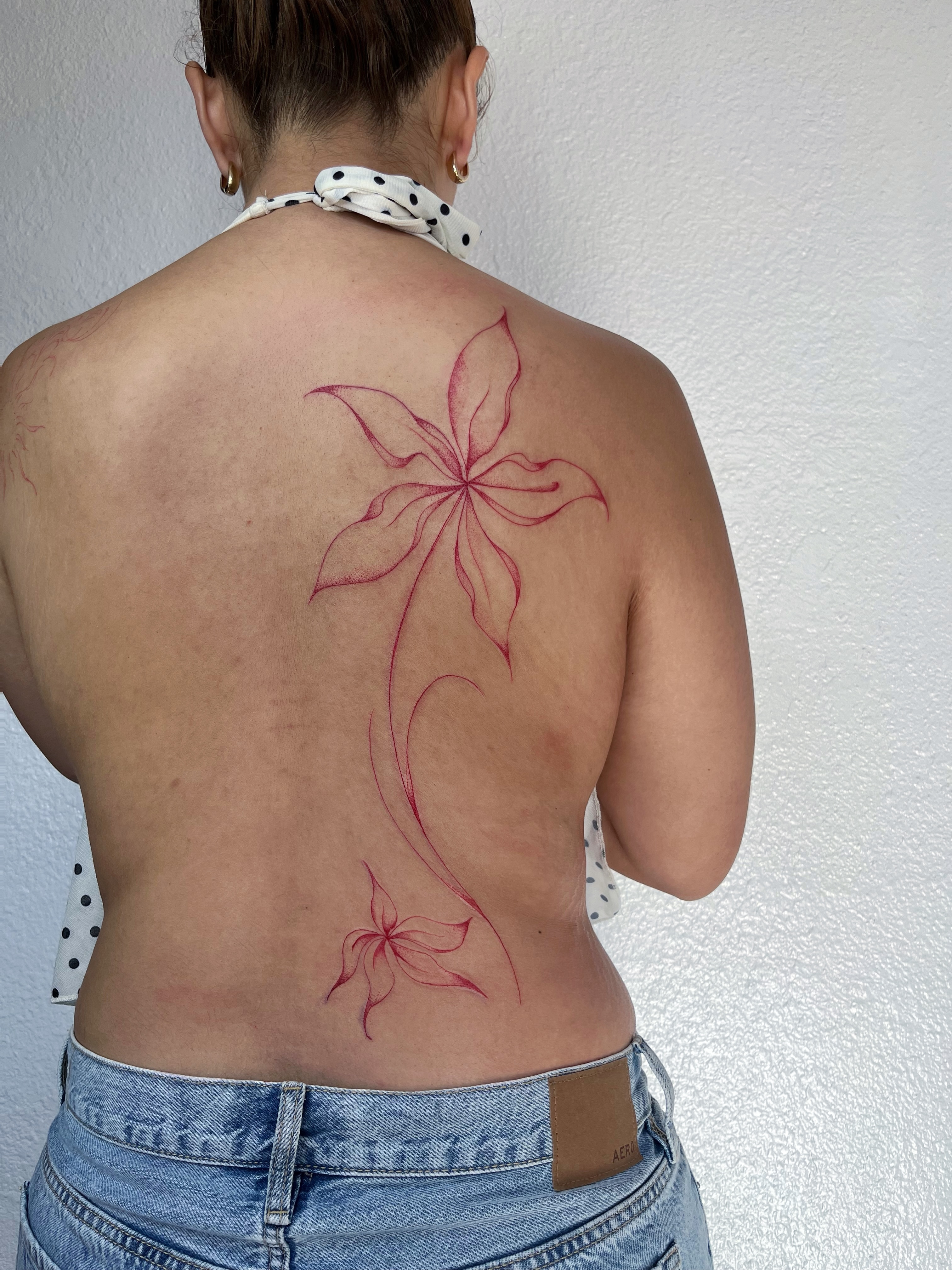 Floral design fine line tattoo on the back by Sara Atamian, San Diego, California