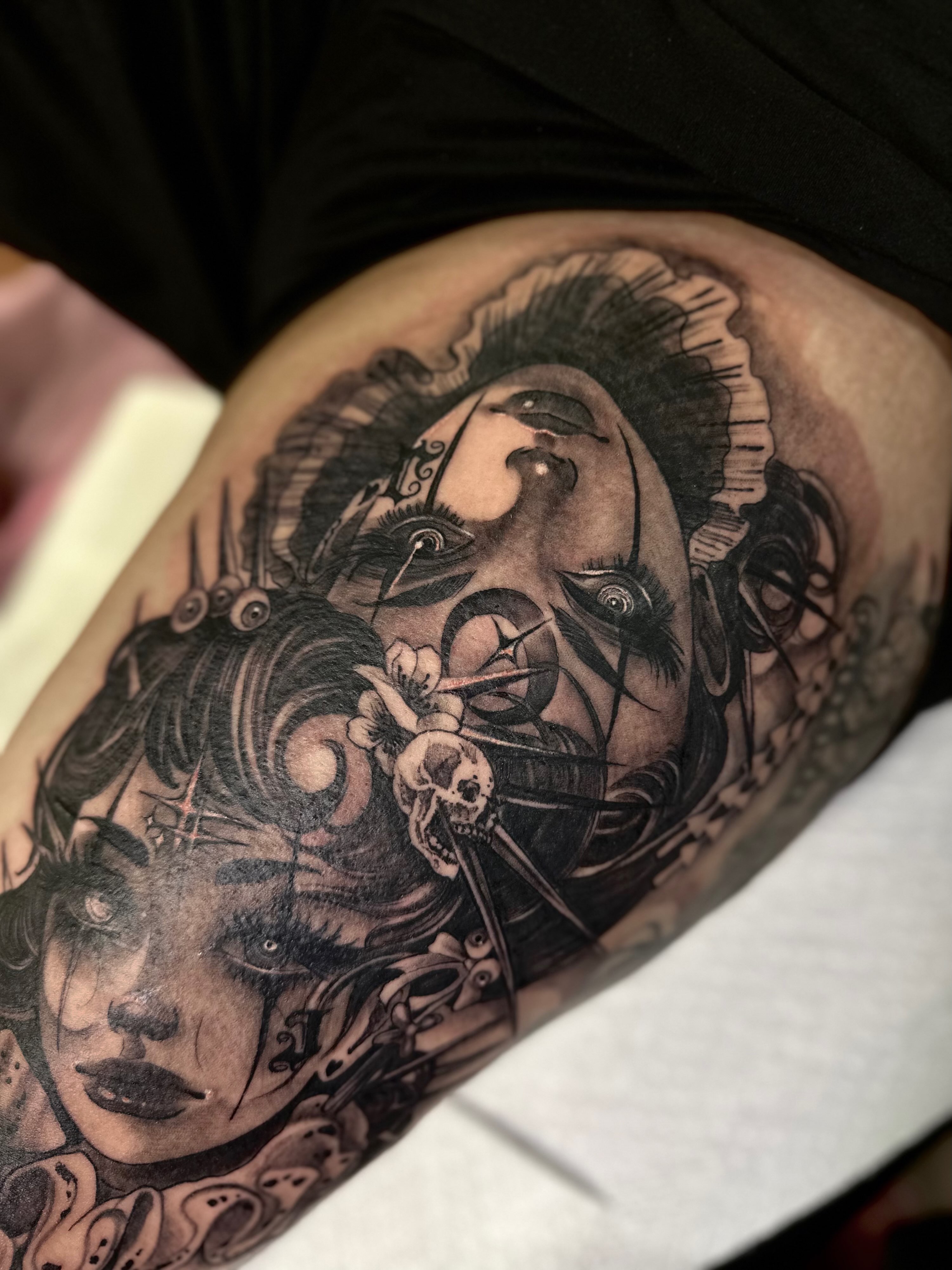 Clown and woman realism tattoo on the thigh by Mathilda Quynh