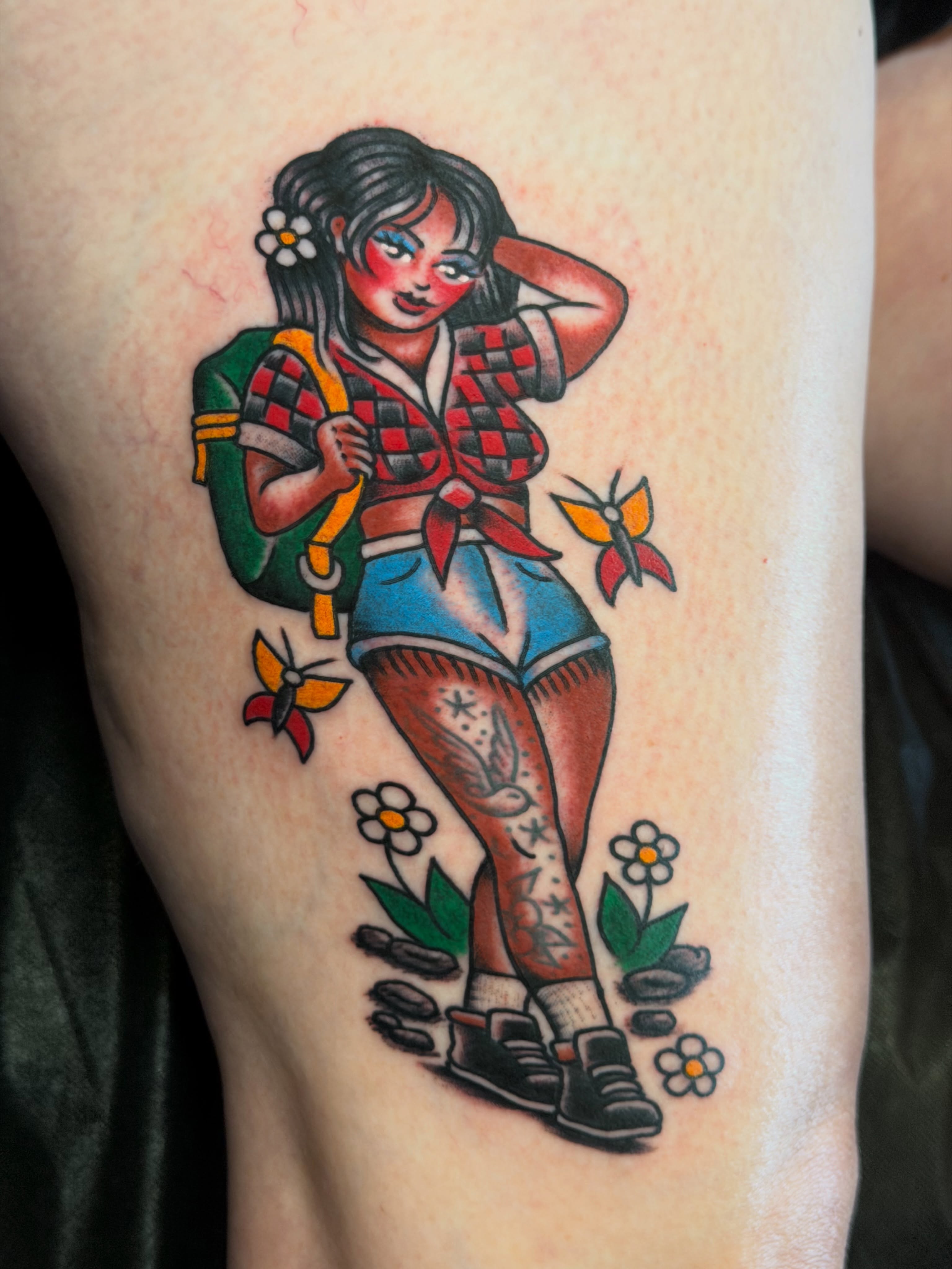 Girl with backpack American traditional tattoo on the thigh by Brandon Bear
