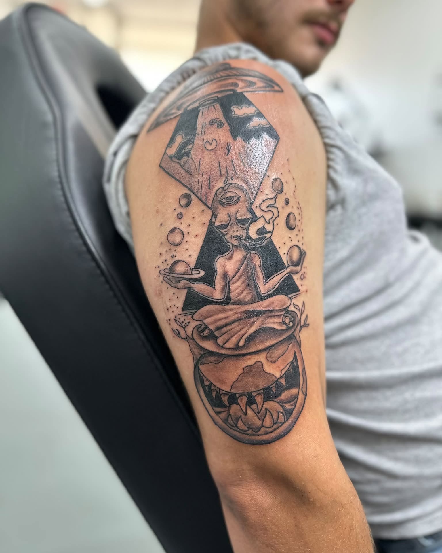 Astronaut meditating geometric tattoo on the shoulder by Brian Lambert