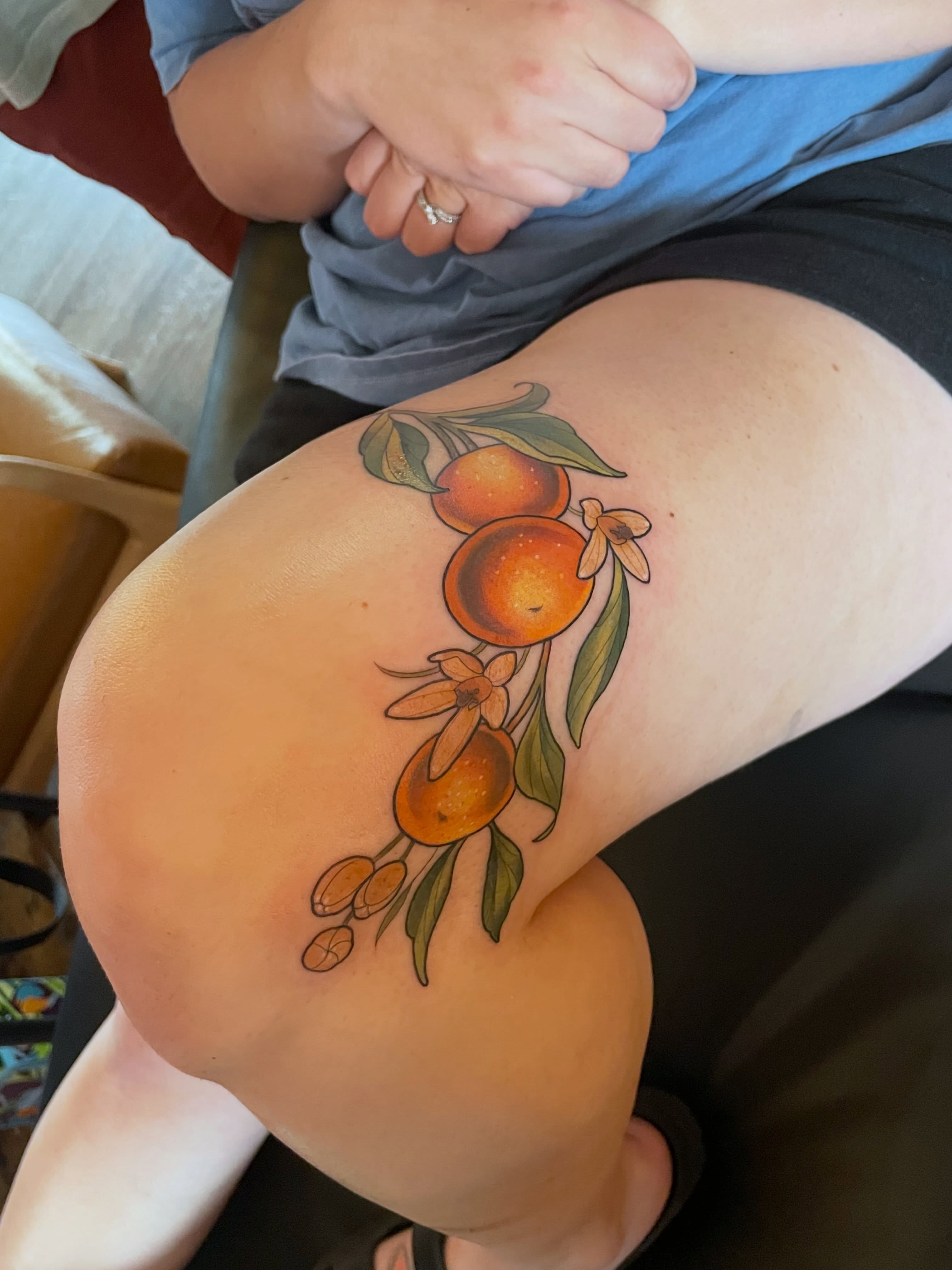Orange fruit realism tattoo on the thigh by ✨Erin Haines✨