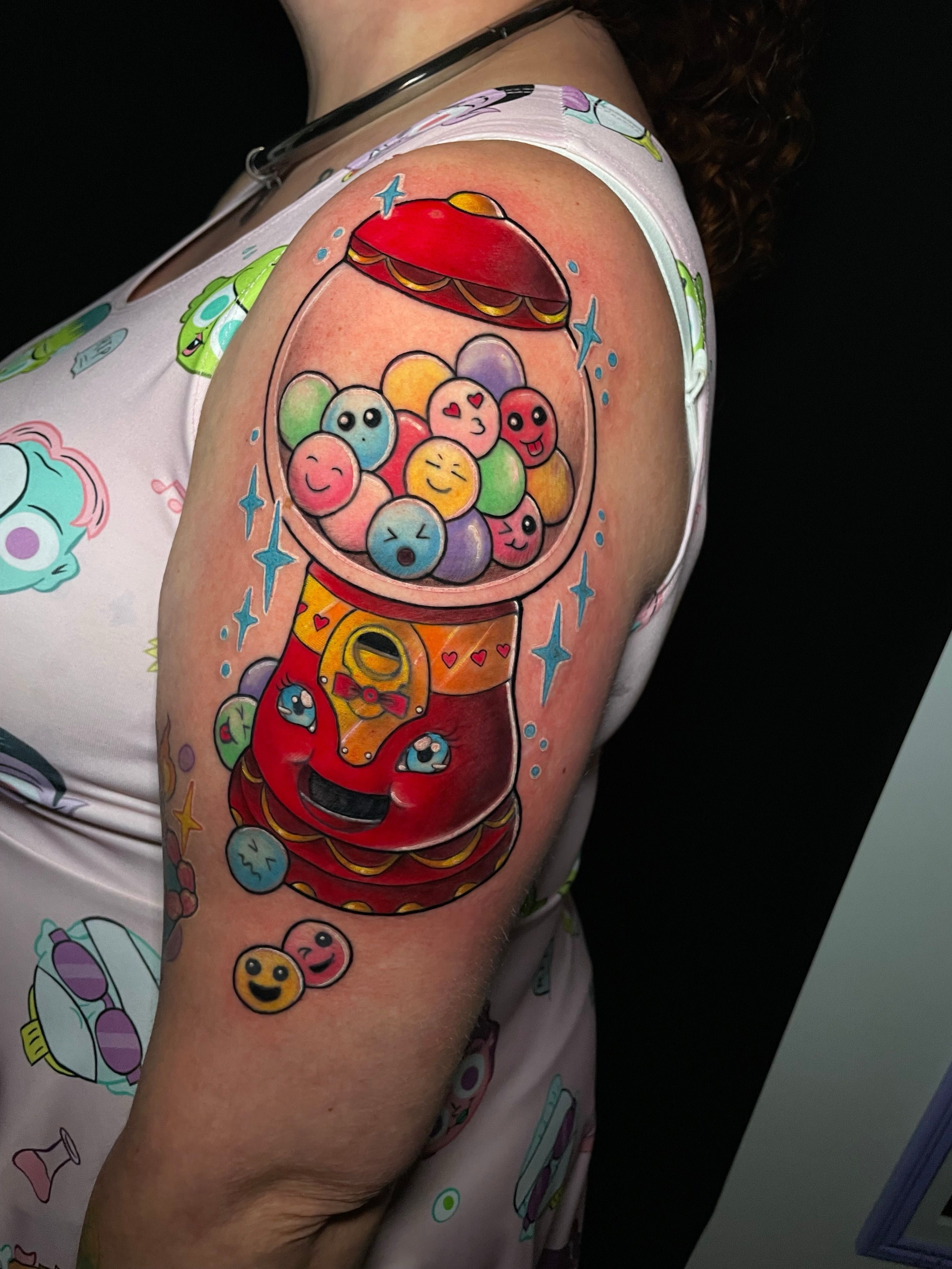 Gumball machine new school tattoo on the upper arm by Tanya Murski