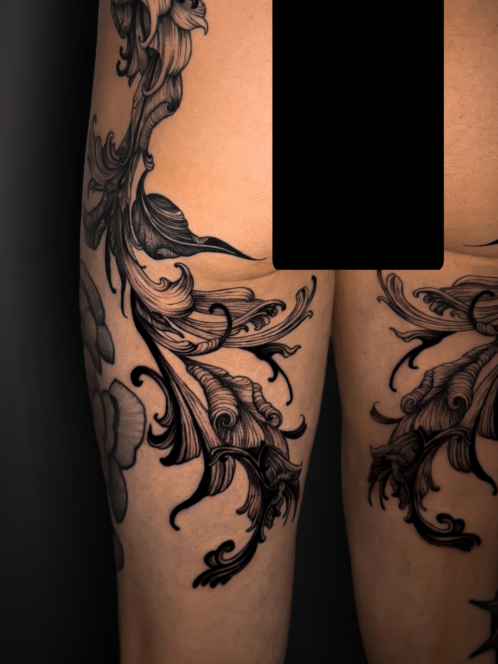 Floral design black and grey tattoo on the leg by Kam Mills