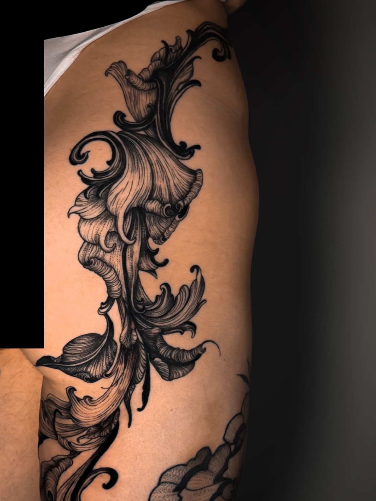 Lily black and grey tattoo on the shoulder by Kam Mills