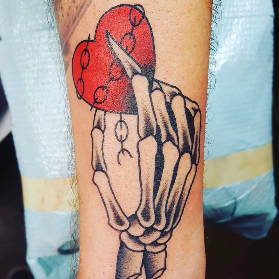 Broken heart with skeleton hand American traditional tattoo on the forearm by Nick Weaver aka gibby sometimes gilbert