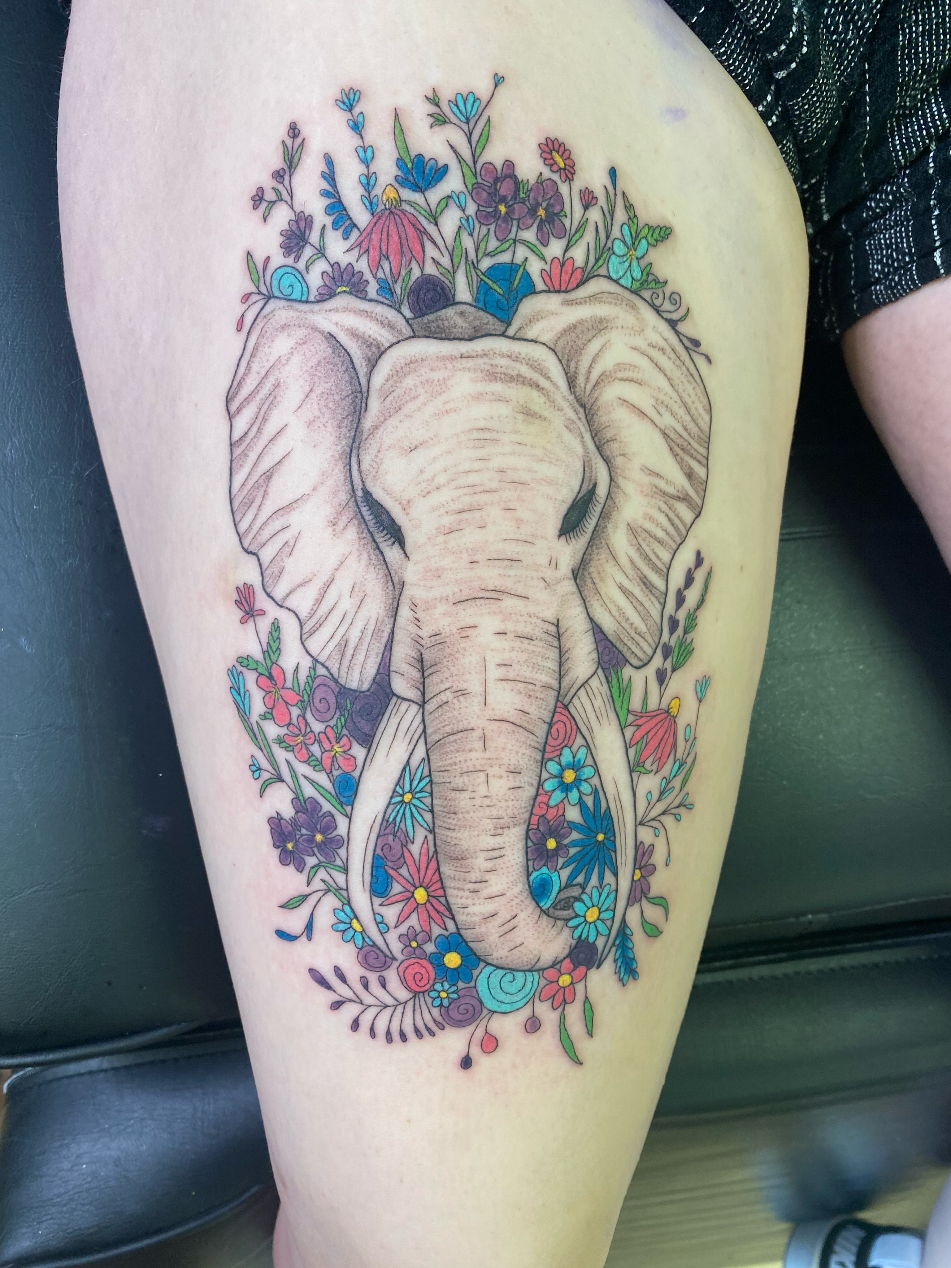 Elephant with floral wreath new school tattoo on the thigh by Katie Leeper