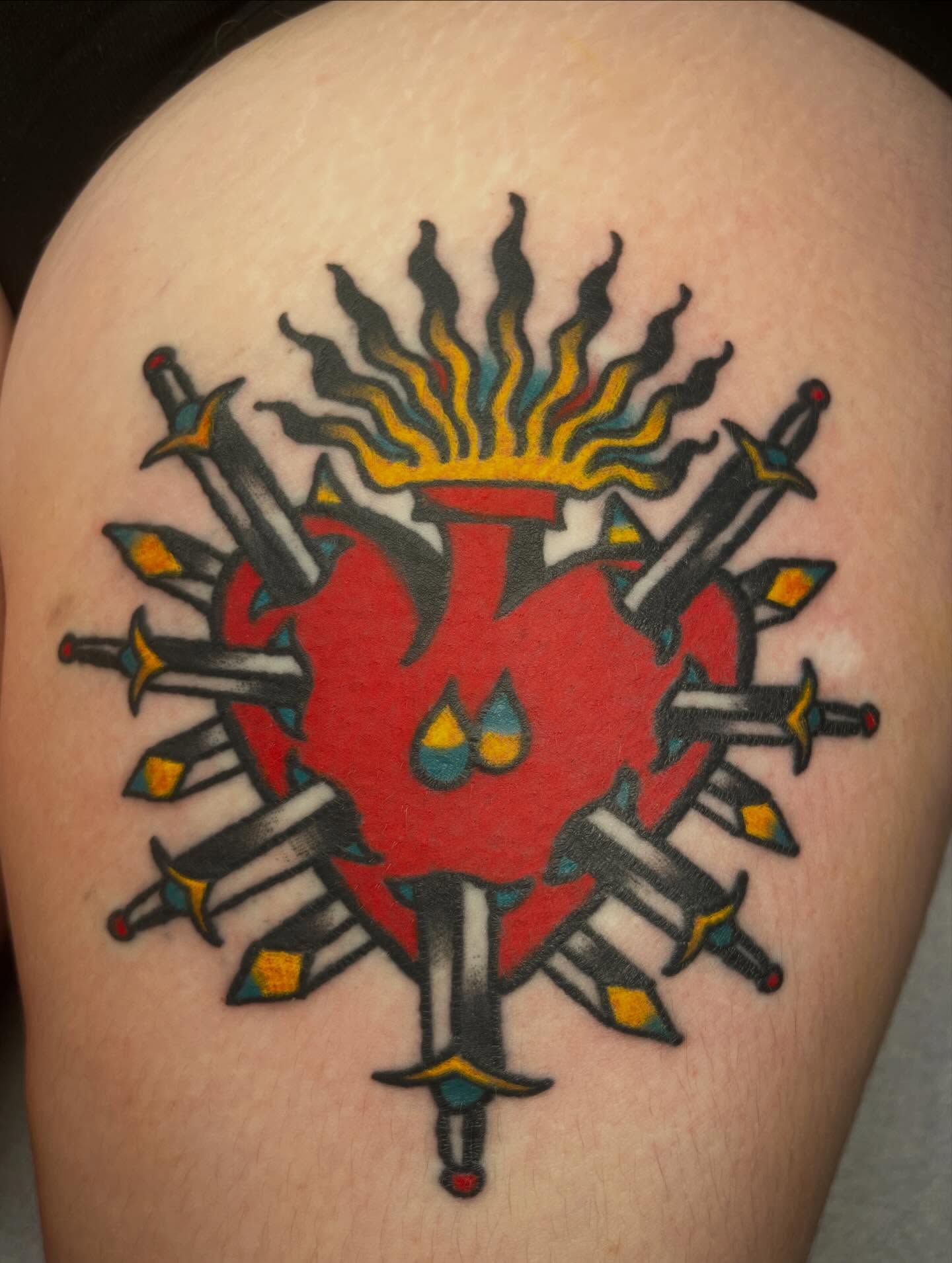 Heart with swords American traditional tattoo on the shoulder by monk