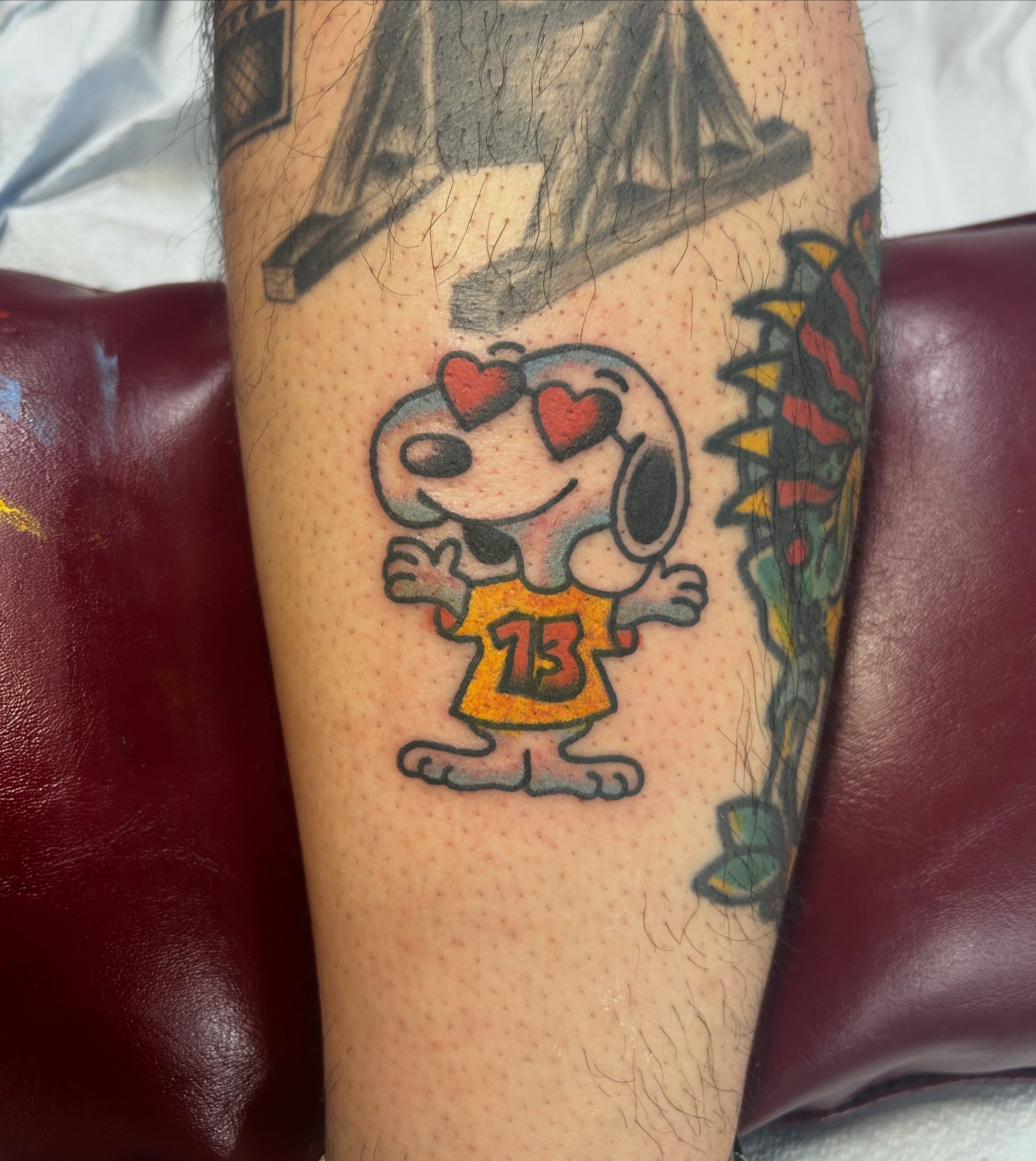 Snoopy illustrative tattoo on the forearm by Tawni Bender