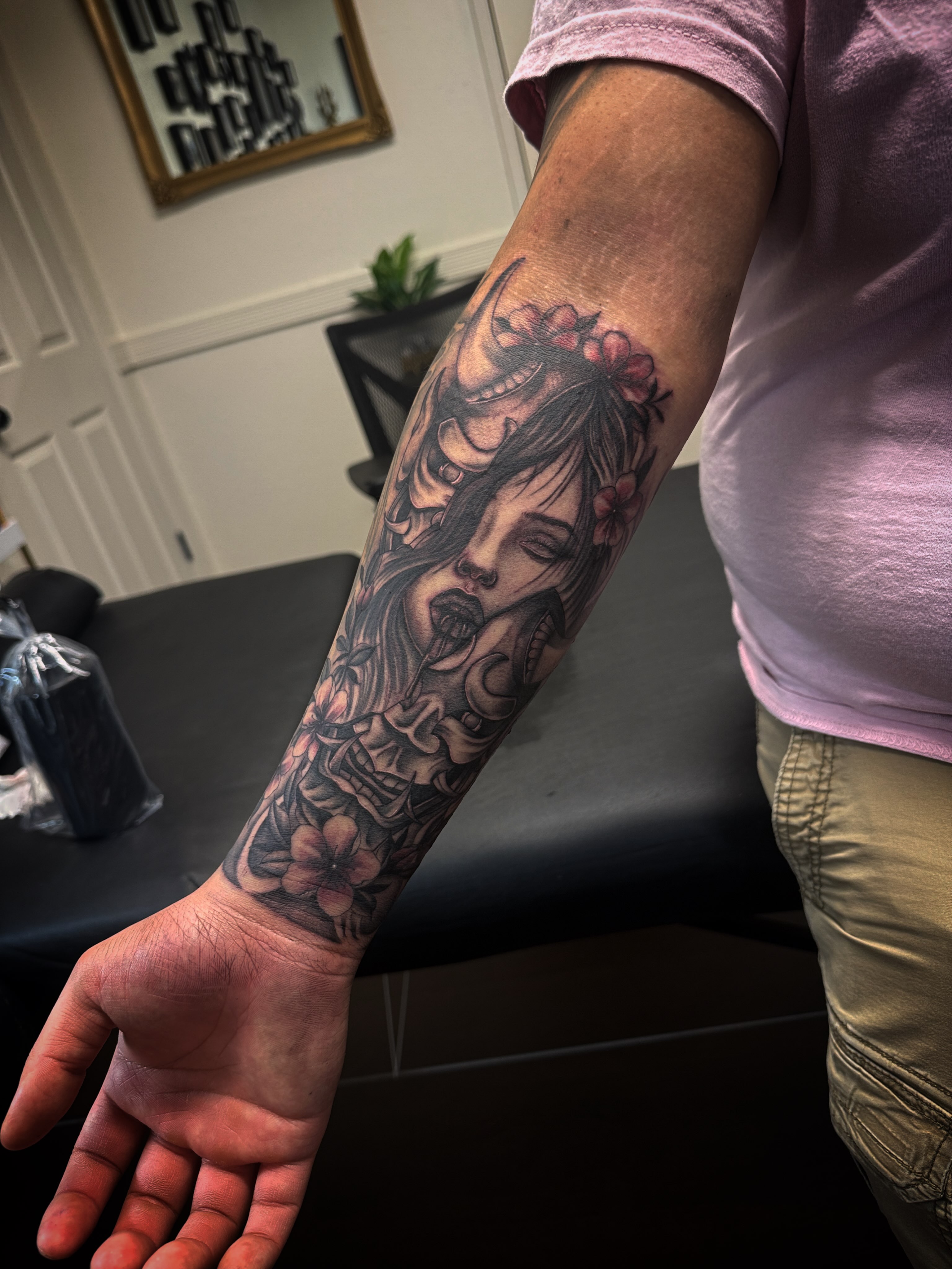 Woman with flowers realism tattoo on the forearm by Sad Girl Tattoos