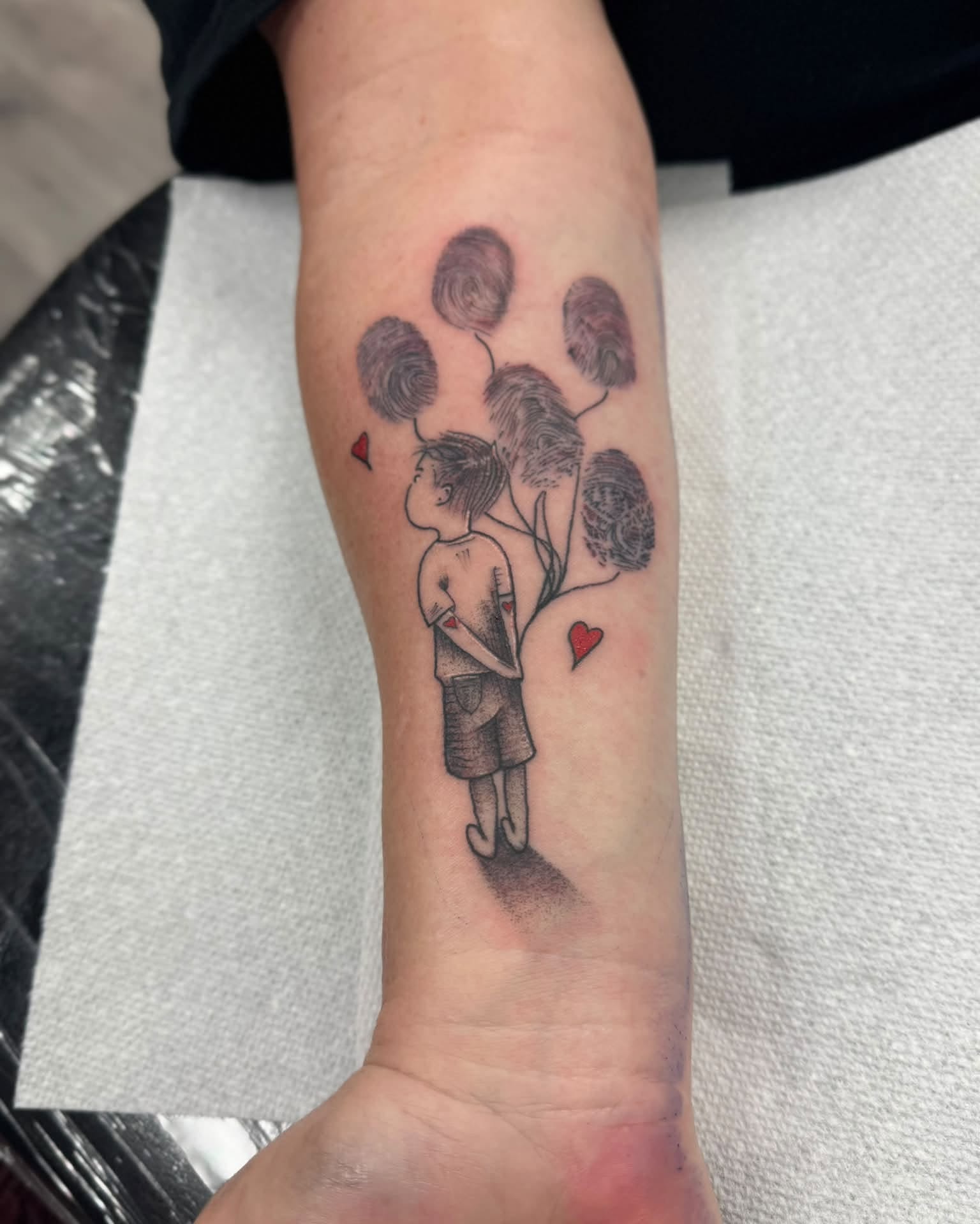 Child with fingerprint tree black and grey tattoo on the forearm by Israel Jacob Woehler