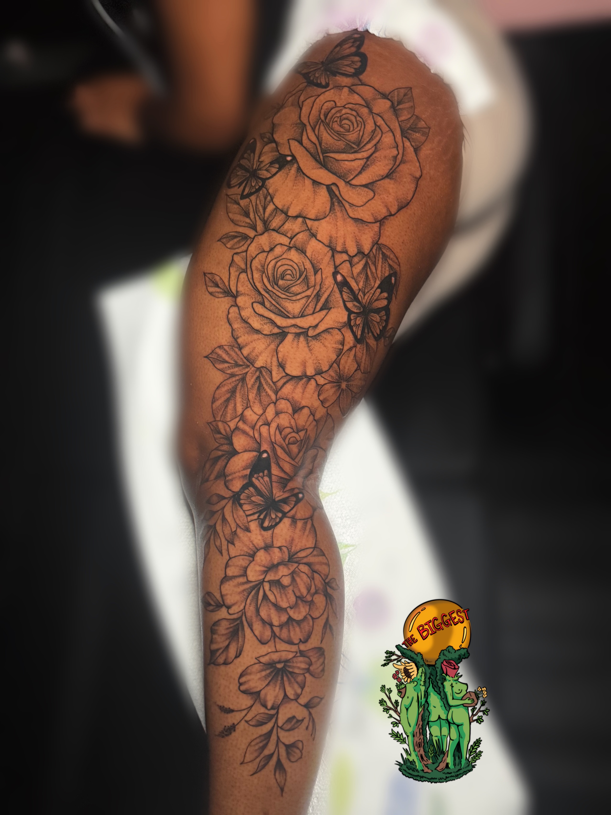 Roses and butterflies black and grey tattoo on the forearm by Marques Neal